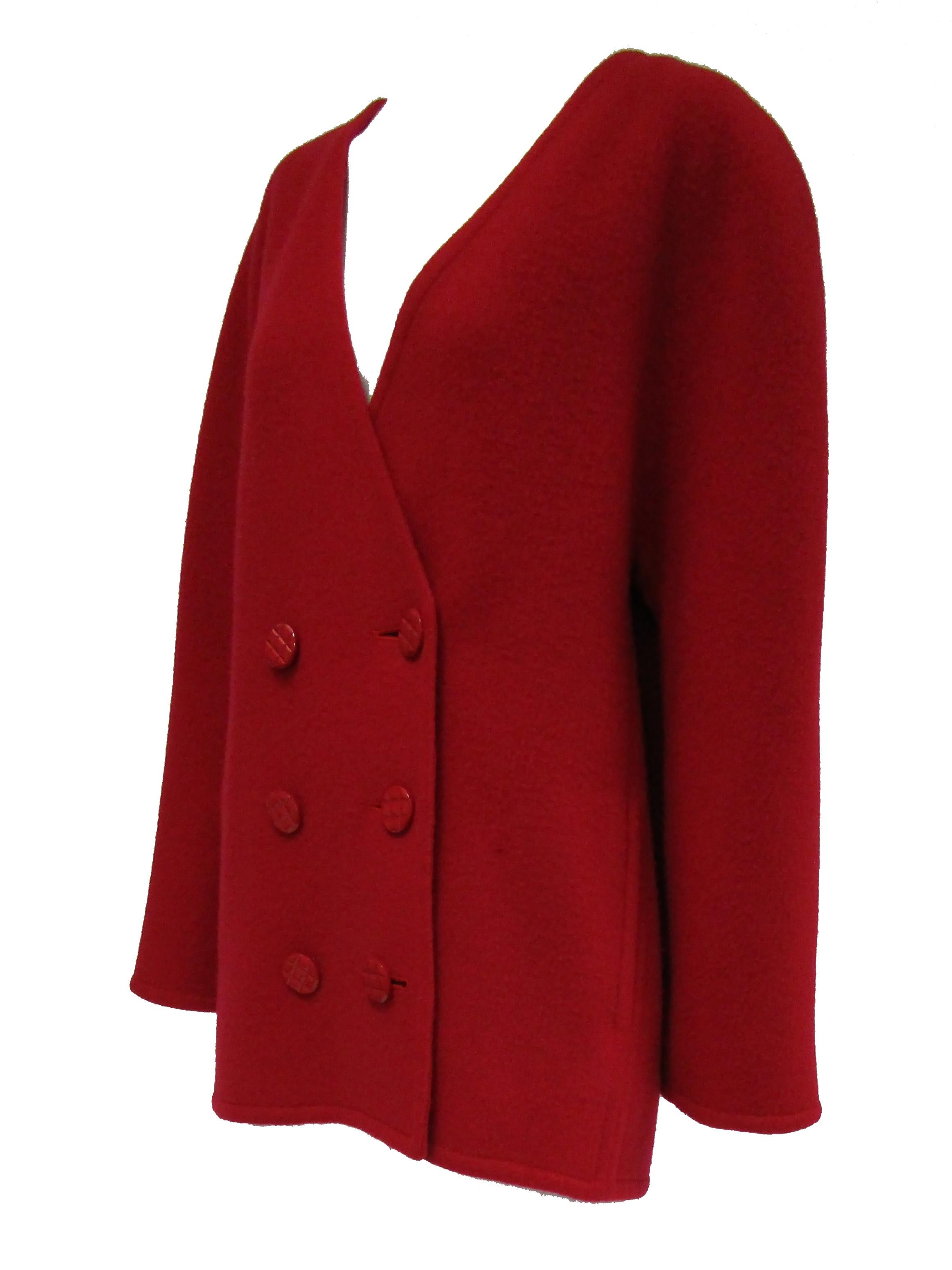  @ La Souer 
Striking bright red jacket by Galanos! This jacket is hip length, with long sleeves and a deep V - neckline. The jacket has rounded, sloping shoulders that give it an avant gard look. The jacket is double breasted with six red acrylic