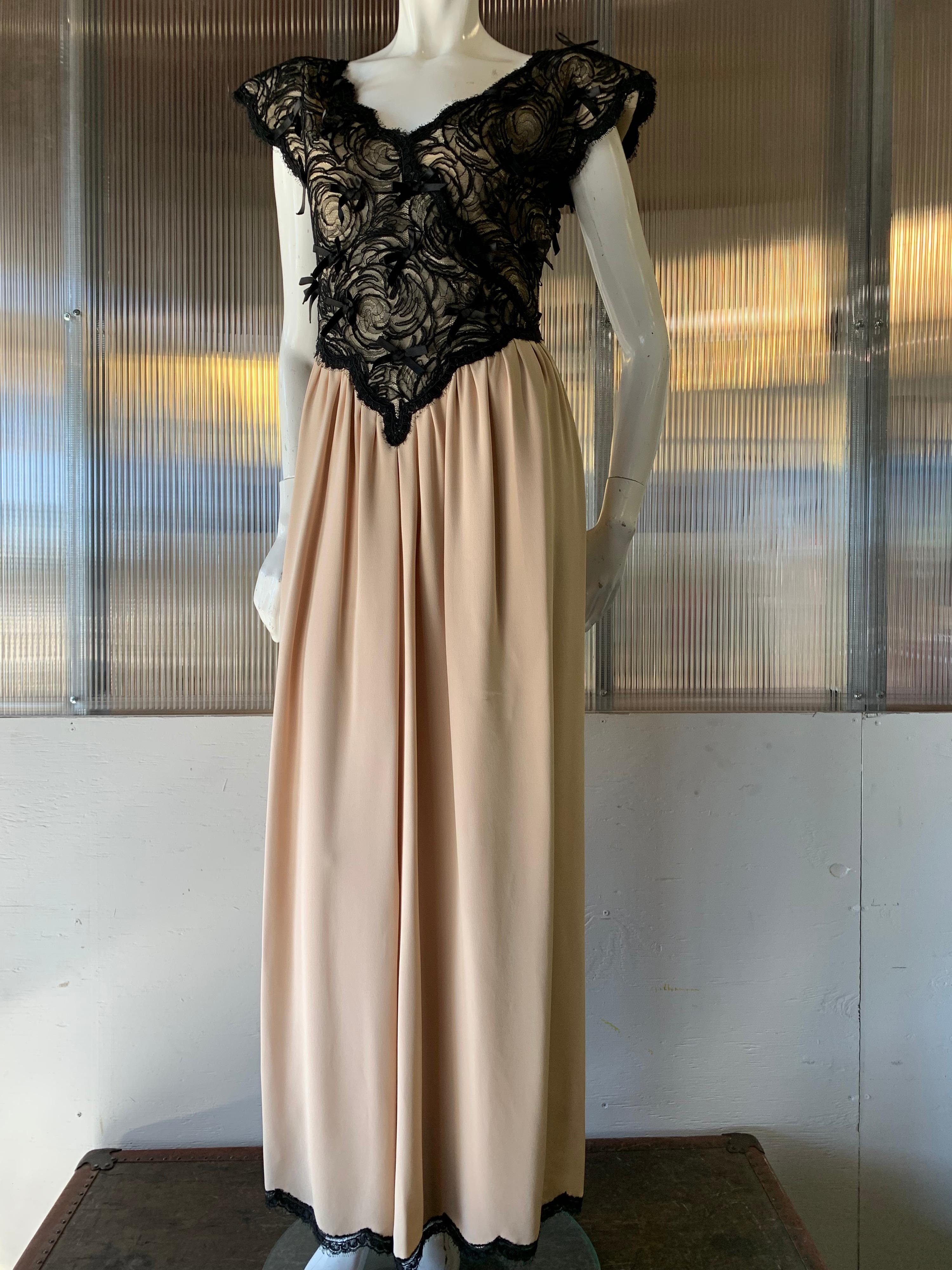 1980s Geoffrey Beene Black Lace & Cream Silk Gown W/ Exaggerated Shoulders. Lined black silk lace surplice bodice embellished with silk satin bows and stiffened butterfly wing sleeves. Deep V-shaped point at bodice hem. A double layered gathered