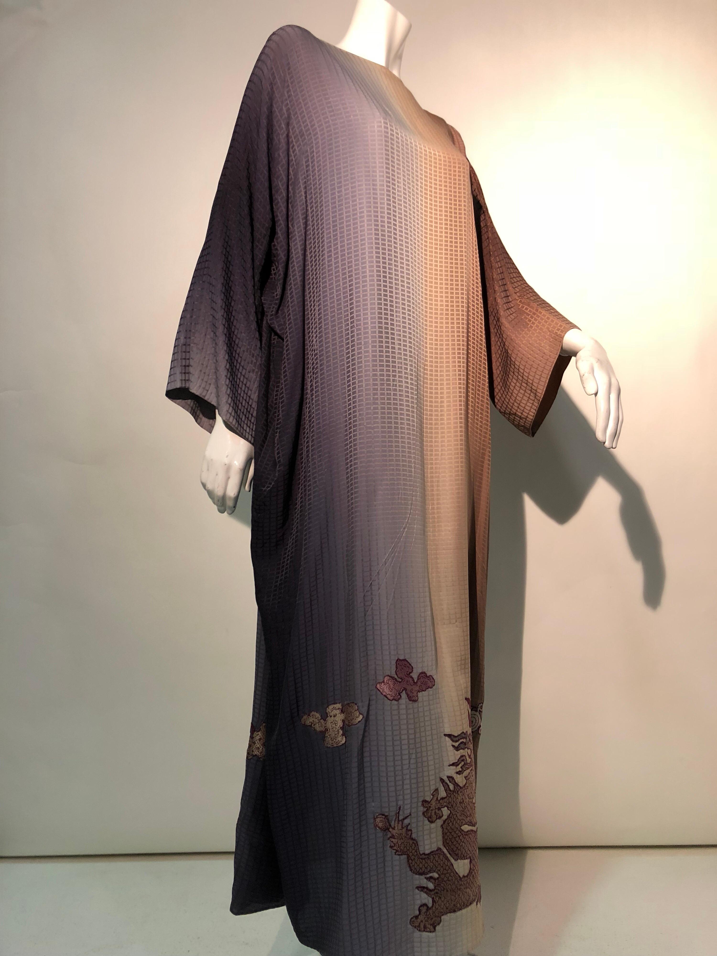 A gorgeous and alluring 1980s Geoffrey Beene silk ombre caftan, fading from gray to sienna and umber hues on a geometric patterned weave that has been embellished with 1920s silk Chinese Dragon motif pieces. 
Tie closures at back. 