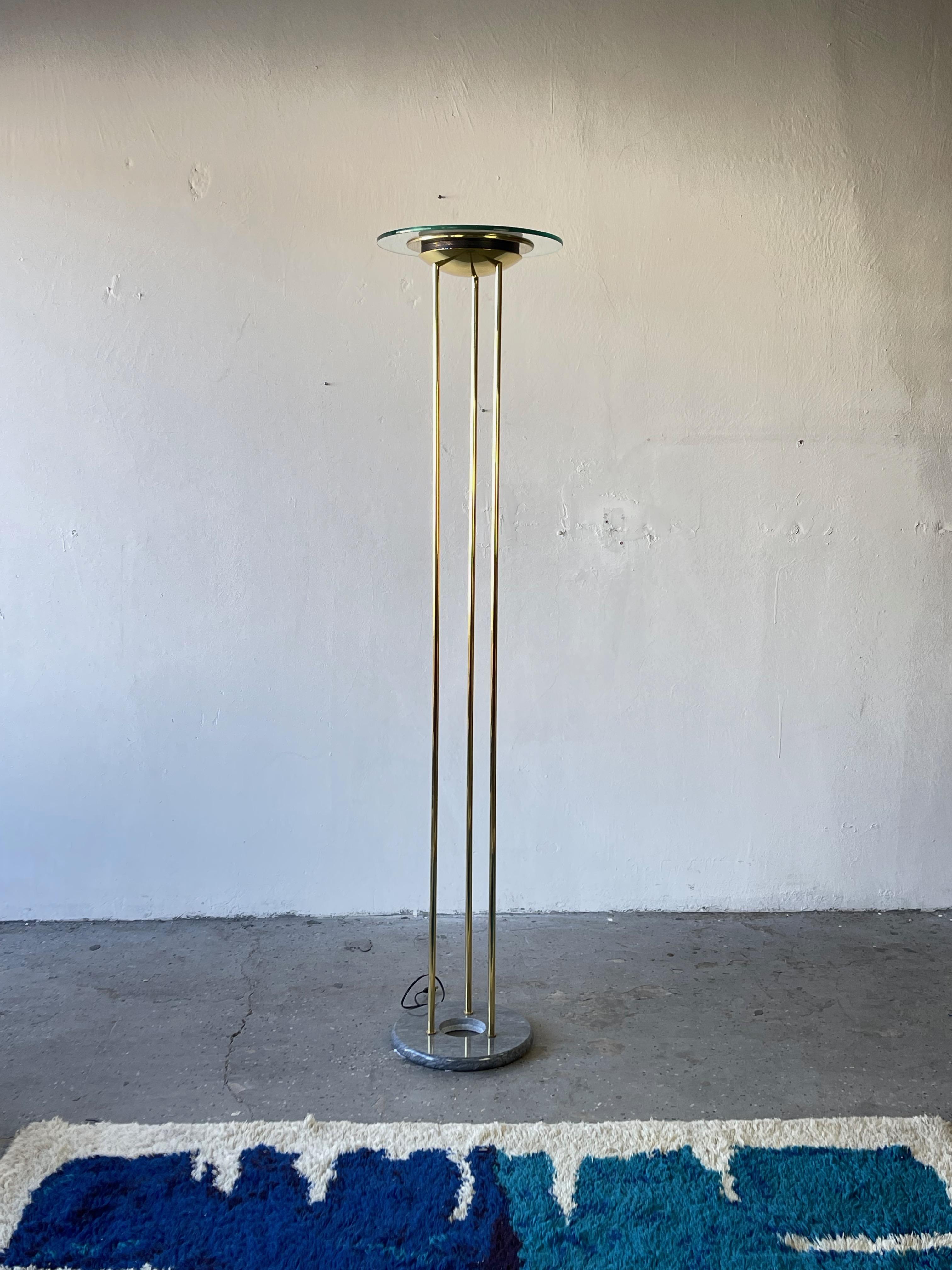 Very striking floor lamp designed by Robert Sonneman for George Kovacs, circa 1980’s. Very well made with polished brass, marble base, green tinted glass reflector

Measures: Height: 73 in.
Diameter: 16 in.

