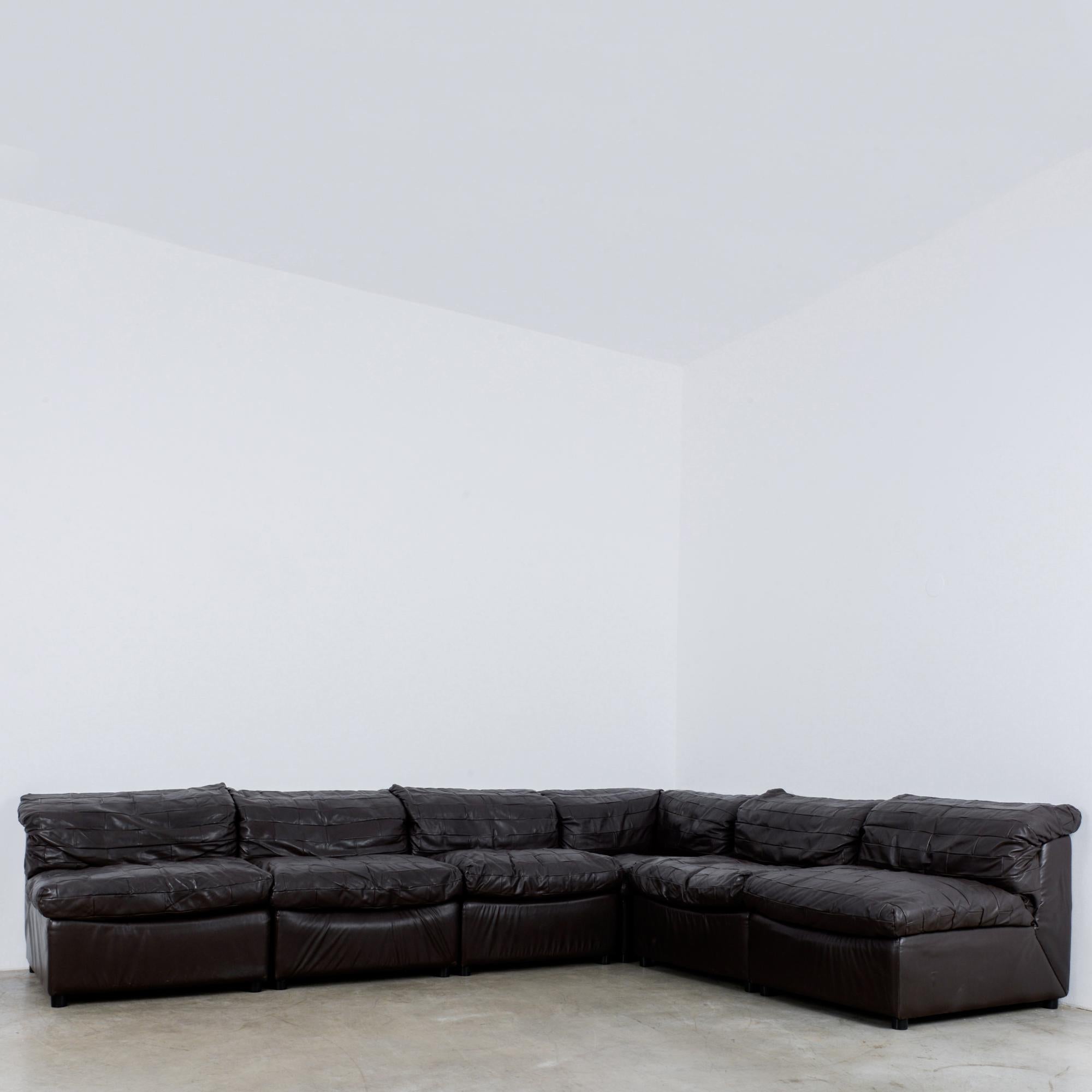 A German leather six-piece sectional sofa produced circa 1980. Plush, luxurious comfort. The running bond pattern of the leather seats and backs makes this couch stand out in any interior. At over four meters long, this sofa is large enough to host