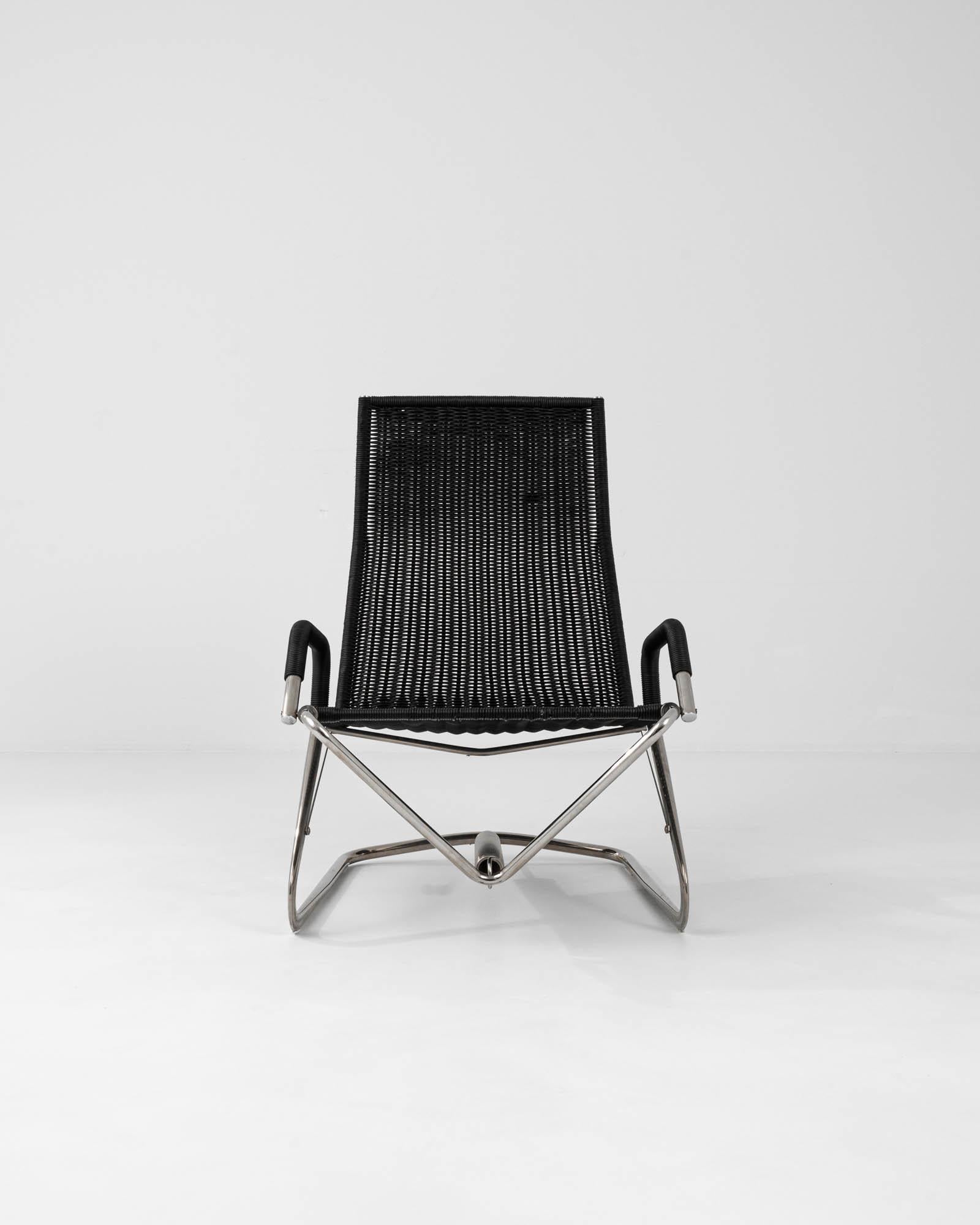 Step into the realm of minimalist design with the 1980s German Metal Armchair by Jean Prouvé. A true representation of functional art, this chair's sleek, chrome-plated frame gleams with the promise of enduring strength and stability. Its ergonomic