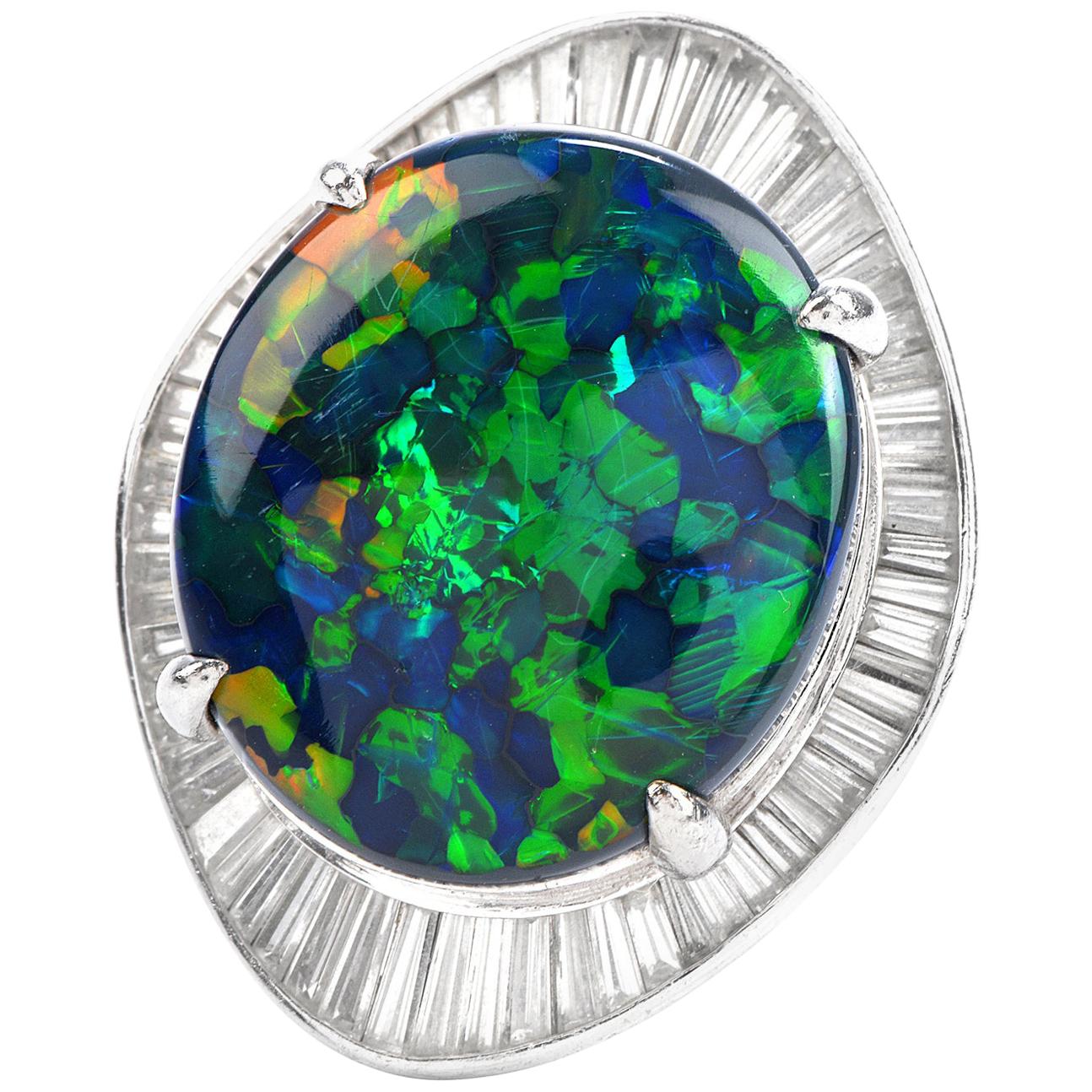 Witness the whole universe in one ring out of this world!

This cosmic looking Black Opal and diamond Ballerina Ring is crafted in Solid Platinum,

Weighing 24.4 grams and measuring 25 mm x 31 mm, 14 mm high, showcasing a prominent Oval Double