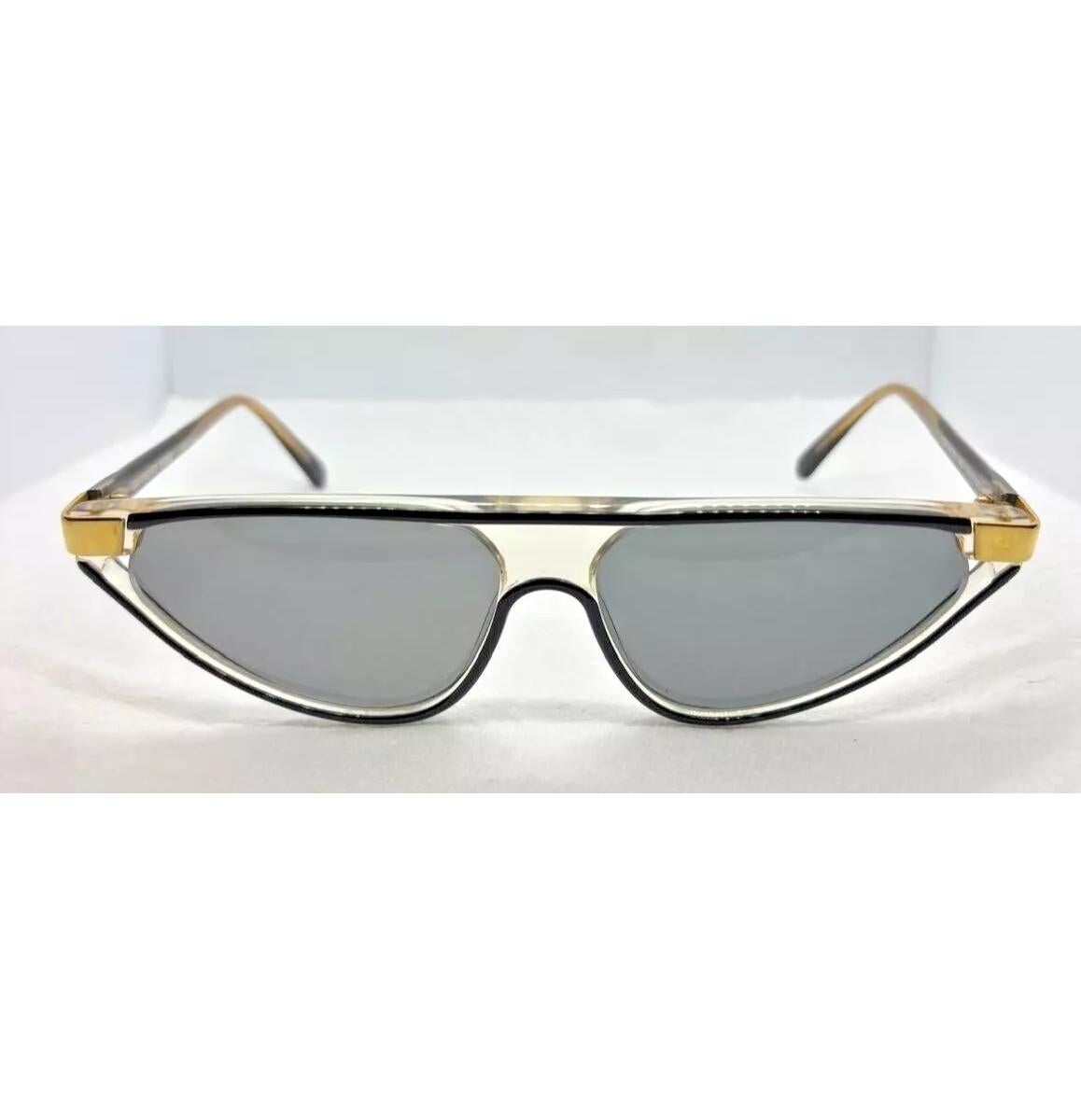 1980s Gianfranco Ferre GFF 361/s sunglasses feature a stylish cat eye shape with black plastic frames and gold trims, exuding an Art Deco-inspired look. Made in Italy in the 1980s, they are a unique piece of eyewear that perfectly captures the