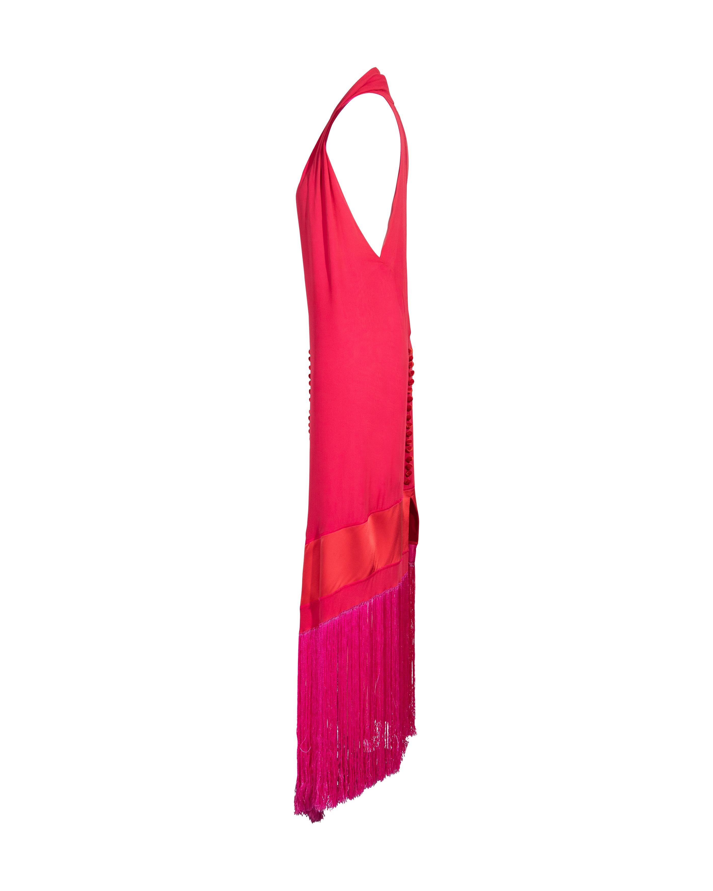 1980's Gianfranco Ferre (attributed) red silk midi dress with hot pink fringe. Red silk chiffon dress with long hot pink fringe hem. Features oversized red velvet buttons on back and front. Deep halter neckline with open cutout back. Asymmetrical