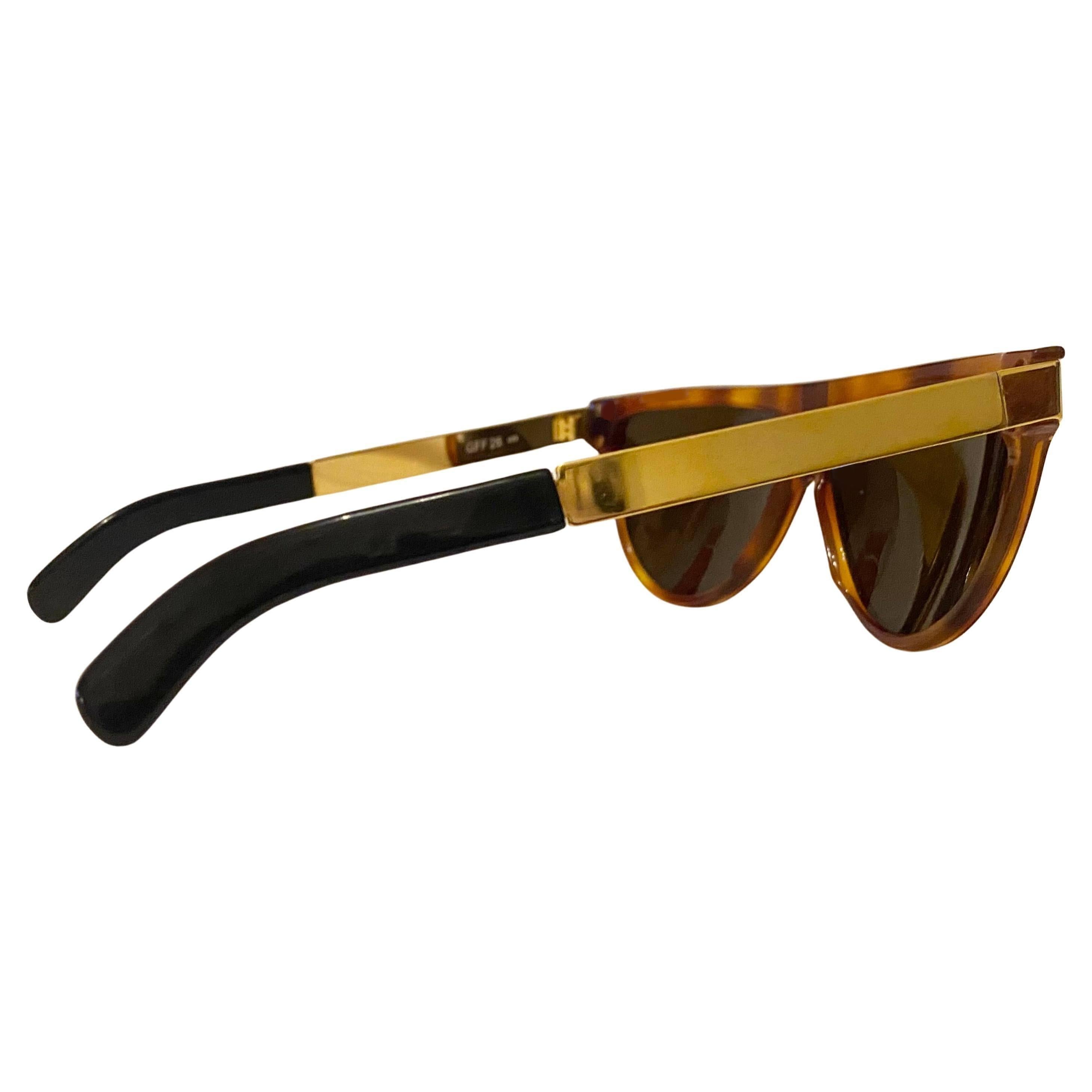 Gianfranco Ferre GFF 26 Tortoise Frame Sunglasses , gold metal arms, Made in Italy 

Measurements 
Frame width: 14.5cm/5.6in
Lens width/height: 6cm/2.4in 
Bridge: 2.5cm/1.2in 
Arm length: 15cm/6in

Condition: 1980s, vintage, very good, no marks on