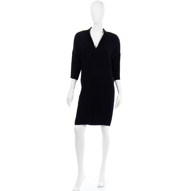 This is a fabulous little black crepe evening dress designed by Gianfranco Ferre in the 1980's. This dress doesn't show well in photos, unfortunately, but when worn it has incredible style.  The dress has a loose fitting upper with a more fitted