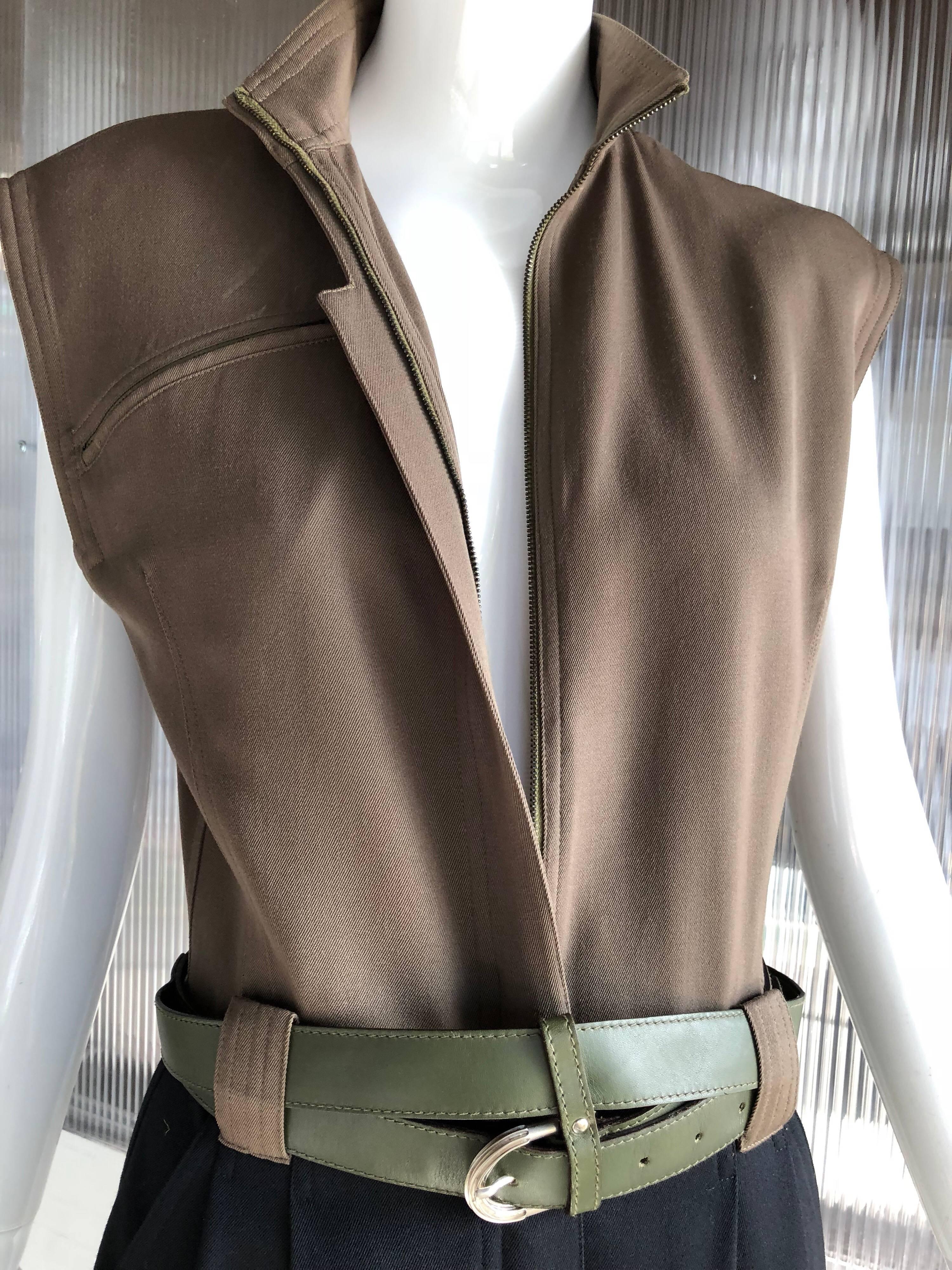 A wonderful 1980s Gianni Versace 2-tone gabardine jumpsuit in black and army green gabardine. Featured with a Gianni Versace olive green double wrap belt. Pleated front, men's-style tailoring. Slightly padded shoulders. Nehru collar. Front zipper. 
