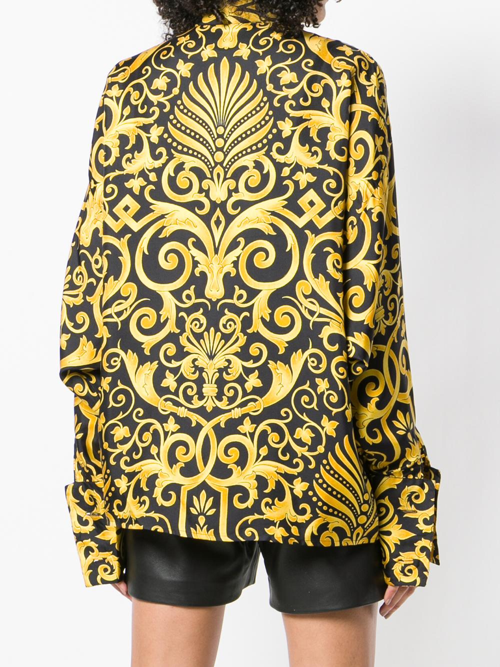 The stylish and iconic Gianni Versace silk oversize shirt features a gold and black baroque printed pattern and a single gold-tone button at collar. With fly front buttoned fastening and double cuffs, the Versace shirt was designed in 1980s.
The