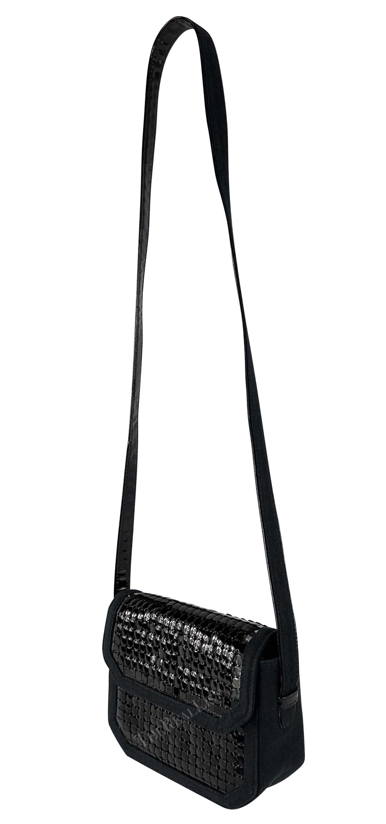 Wir präsentieren eine schicke schwarze Oroton Gianni Versace Umhängetasche, entworfen von Gianni Versace. Diese fabelhafte schwarze Canvas-Tasche aus den 1980er Jahren ist mit einem übergroßen, glänzenden schwarzen Metall-Oroton überzogen. Die