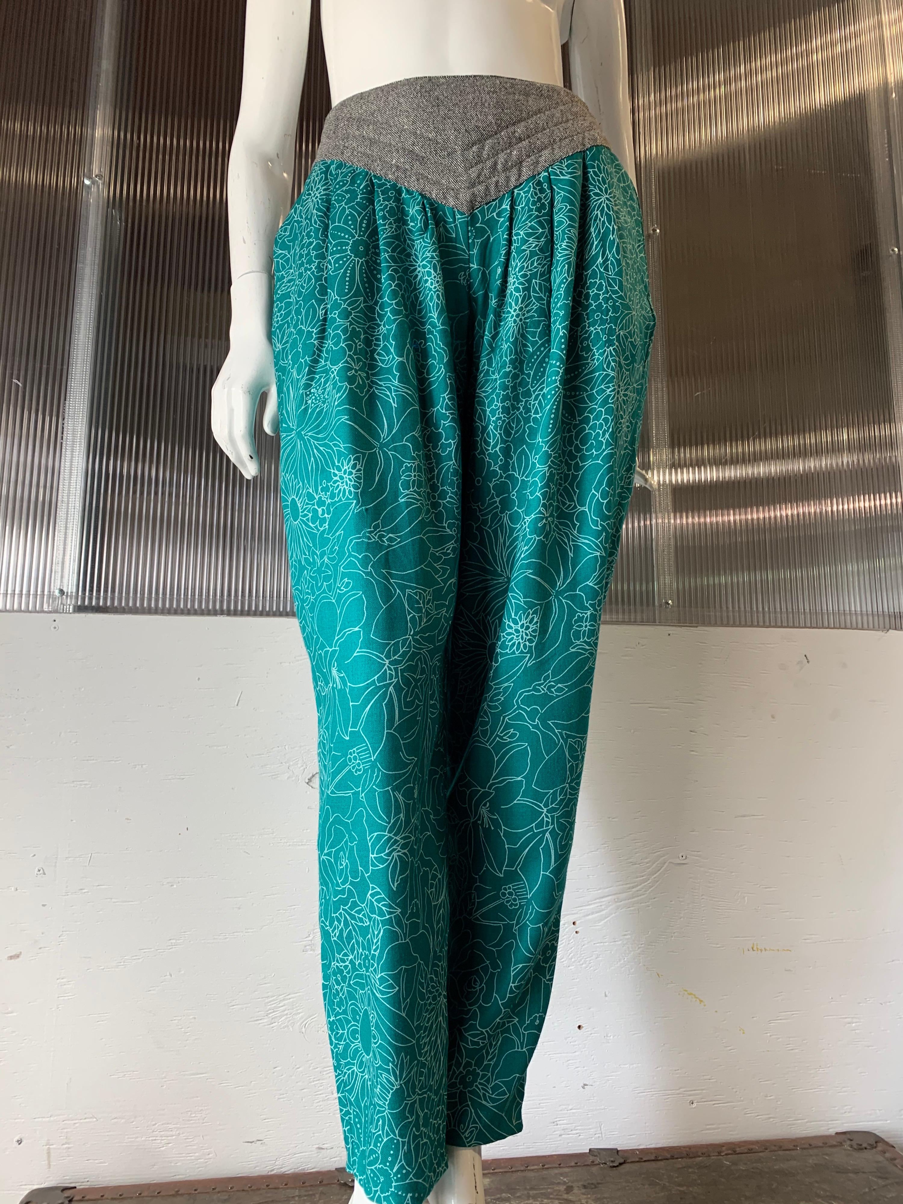 1980s Gianni Versace harem-style silk pants in a teal and white floral print:  pleated at the waist, tapering to a straight cropped ankle. Waistband is black and white trapunto-stitched wool and peaked at front. Italian size 40. US size 6. 