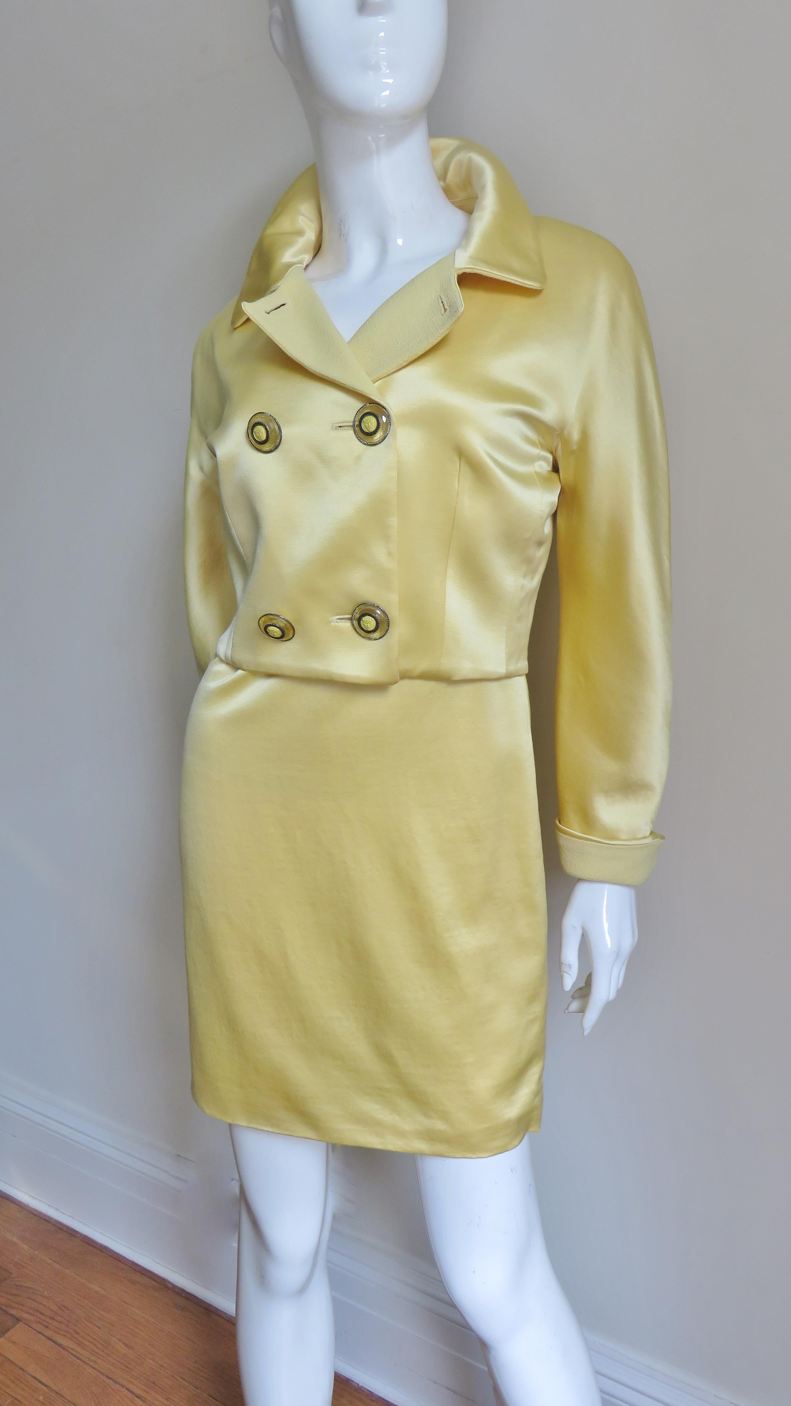 A beautiful yellow silk dress and jacket set from Gianni Versace's Istante collection. The sleeveless scoop neck semi fitted dress is simply cut with a matching yellow light weight wool upper bodice and matching yellow silk skirt potion. It is fully