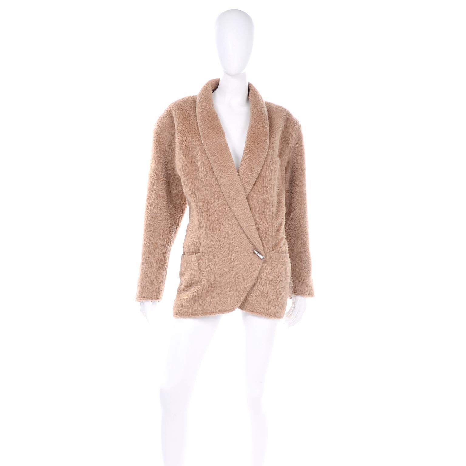 This 1980's vintage Gianni Versace oversized jacket is absolutely amazing! We love the fuzzy camel color alpaca wool blend for this particular silhouette.  This jacket has shoulder pads, 3 functional pockets and an internal button closure to create
