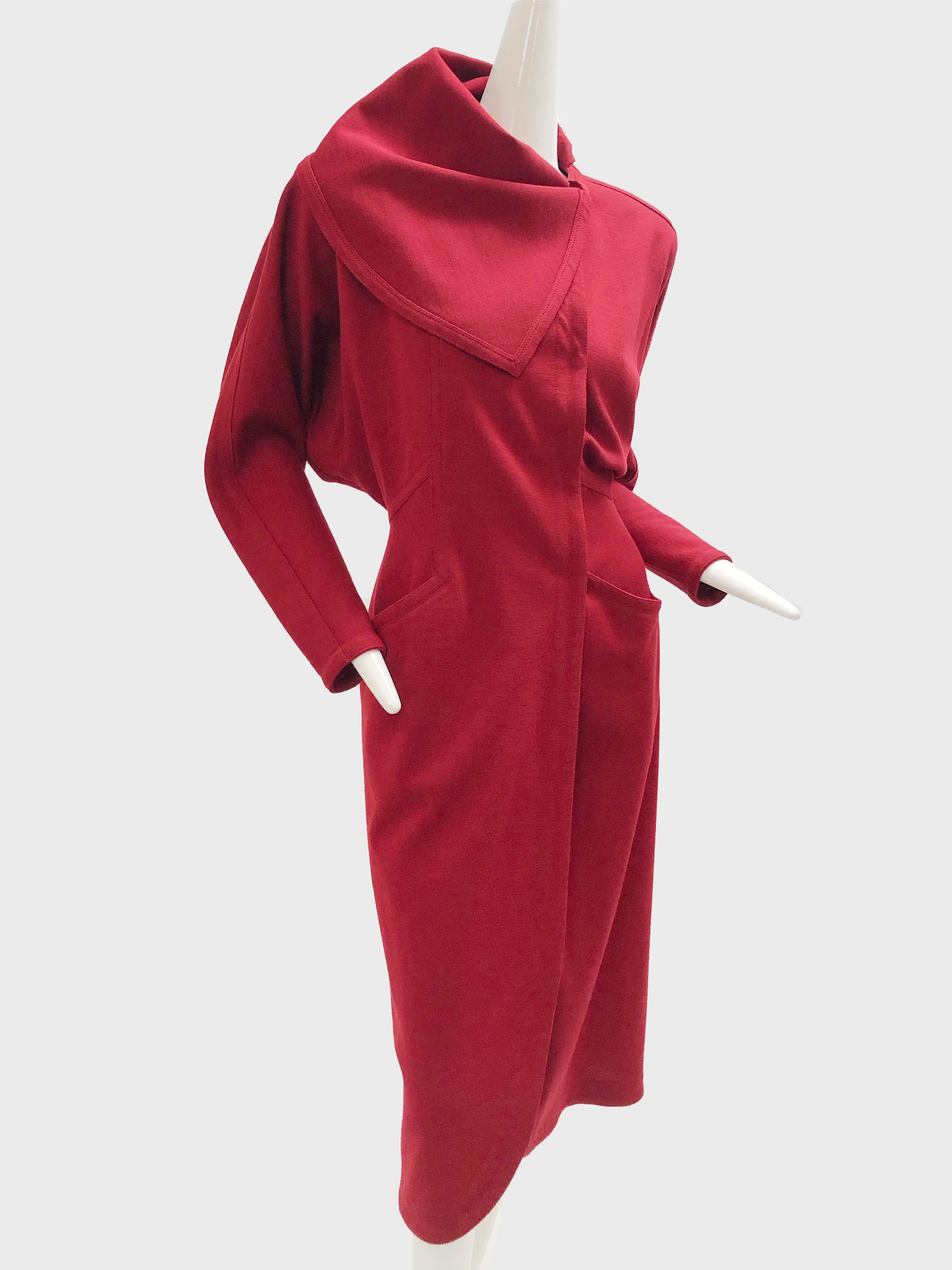 A beautiful 1980s Gianni Versace red wool jersey, wrap-style coat dress with dolman sleeves, hidden buttons at front and an attached foulard. Will fit approximately a US size 0-4.
