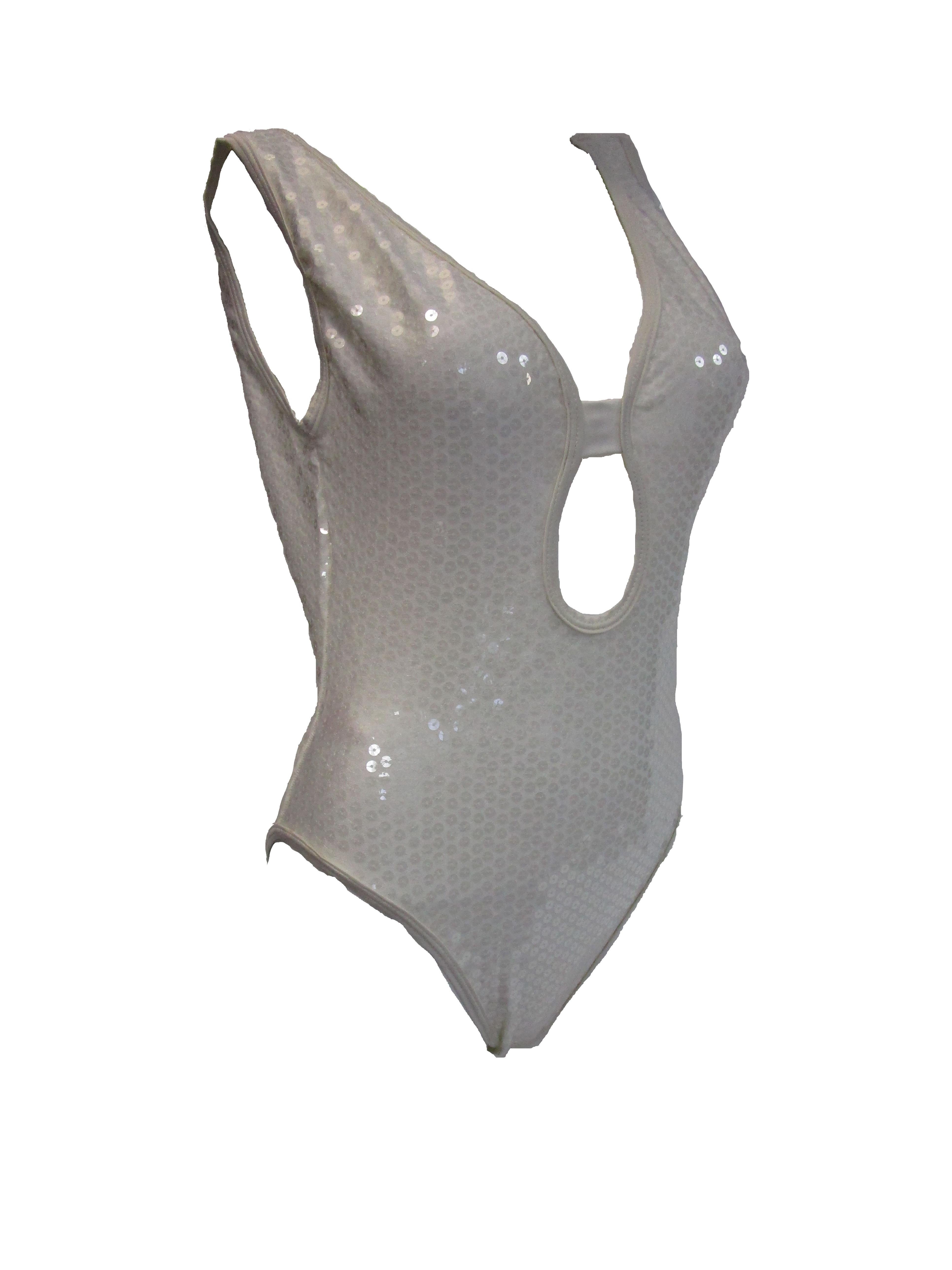 
Steal the spot light with this sparkling one piece bathing suit by Gideon Oberson!
The bathing suit has a scooped back and a skirt that can be worn when you want to cover a bit more!
The sequins throughout are clear and glisten under the summer