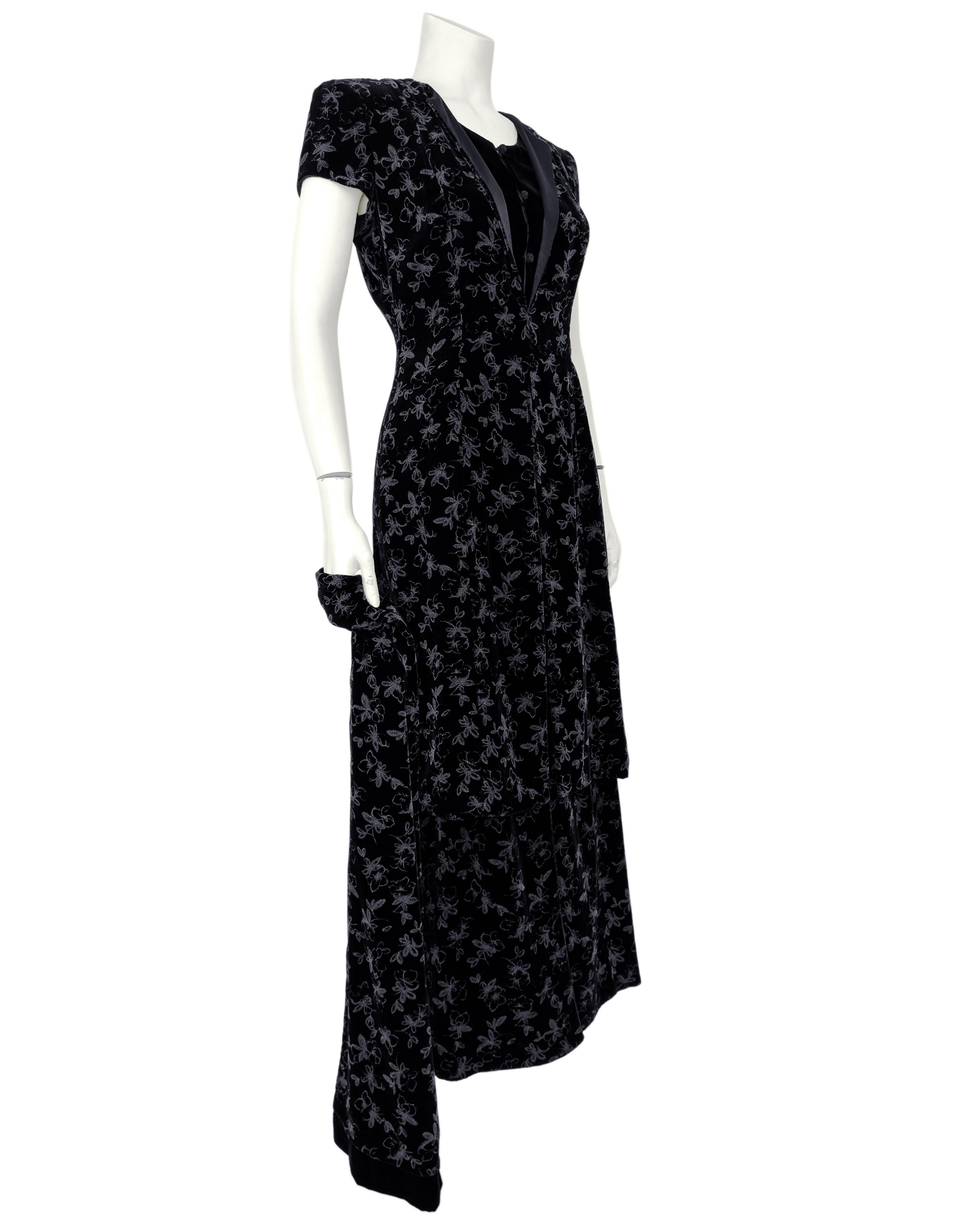 Late 1980s Armani black painted velvet long skirt and tunic ensemble with matching wrap. The skirt has a slit up the front to the knee and zips up the side with a hidden zip. The tunic zips up the back, has cap sleeves with shoulder pads and a slit