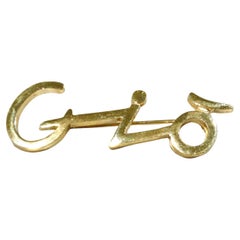 Spilla Giorgio Armani "Gio" placcata oro degli anni '80