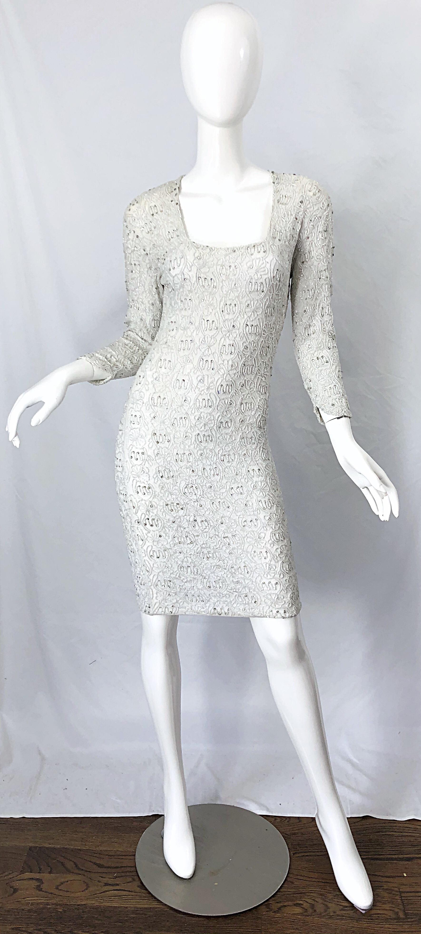 Beautiful vintage 80s GIROGIO di SANT ANGELO white beaded and rhinestone encrusted bodycon dress ! Features a white lace rayon fabric with thousands of hand-sewn sequins, rhinestones, and beads throughout. This dress was from the era when Sant