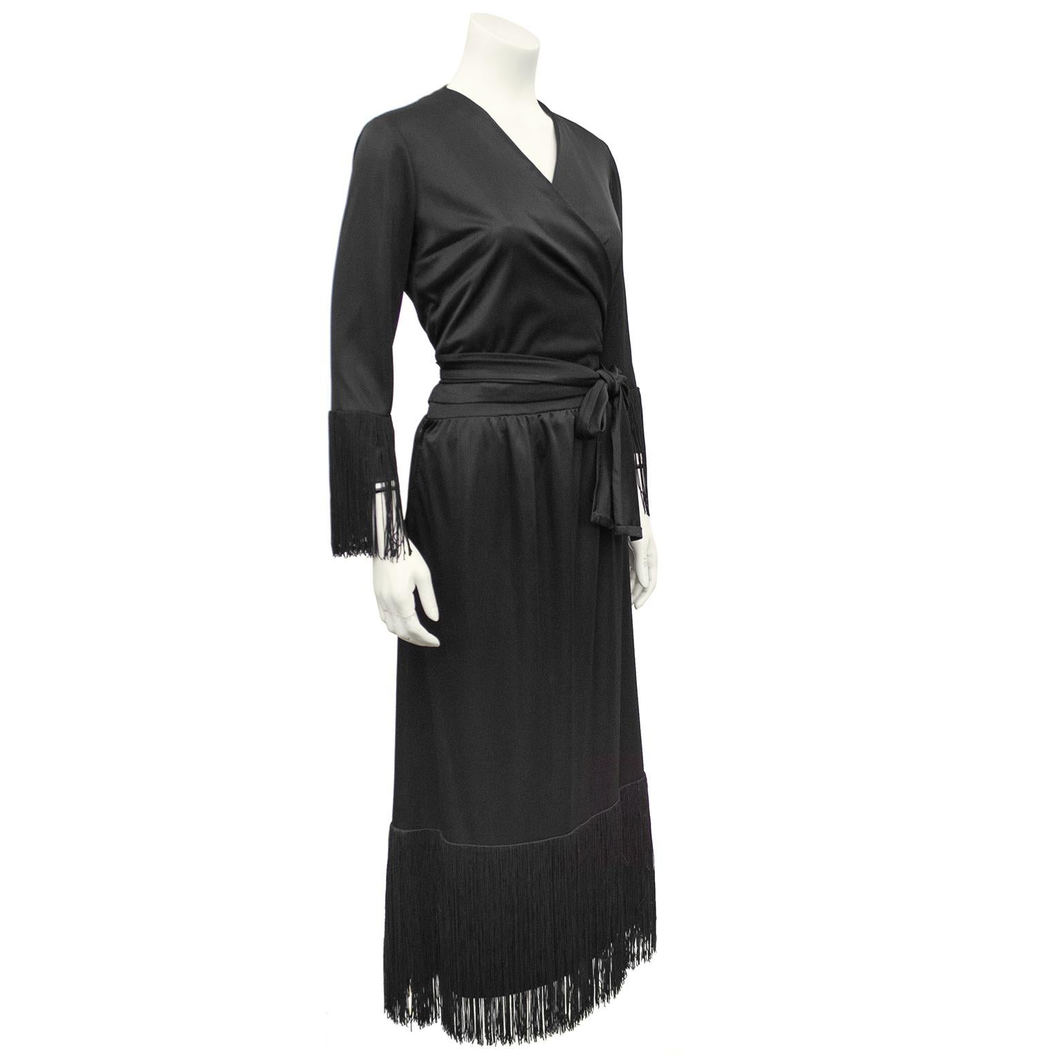 Stunning Givenchy 2 piece set from the 1980s. Black polyester with wrap style with large sash at waist that can be tied to your liking. Long fringe trim at wrists and hem. V neck. Excellent vintage condition. Fits like a US size 6.