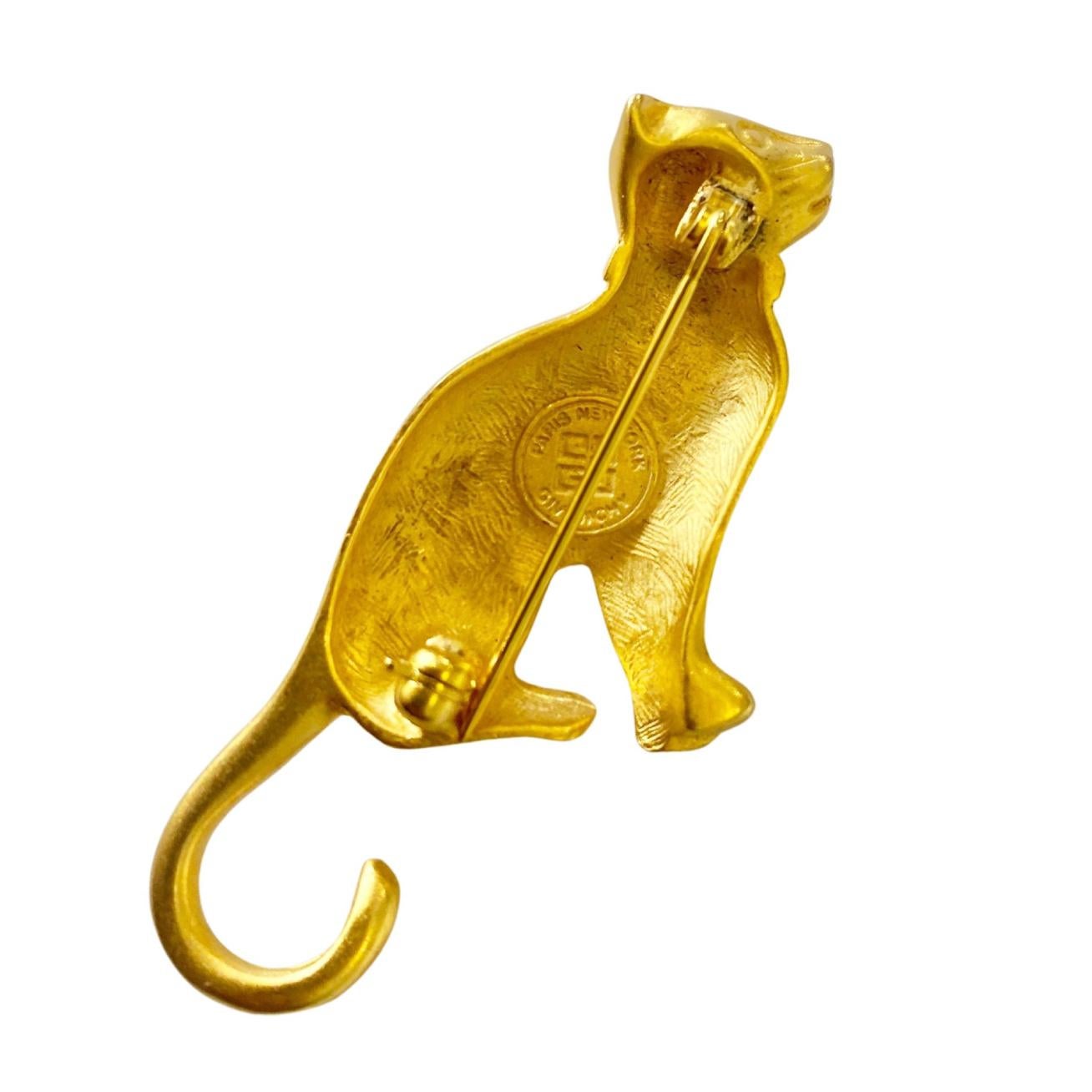 Opulence and glamour of the 1980s with this exquisite Gold Tone Metal Cat Brooch from Givenchy. Paris New York. This iconic brooch embodies the luxurious spirit of the '80s, evoking the elegance and extravagance of that era. An exquisite addition to