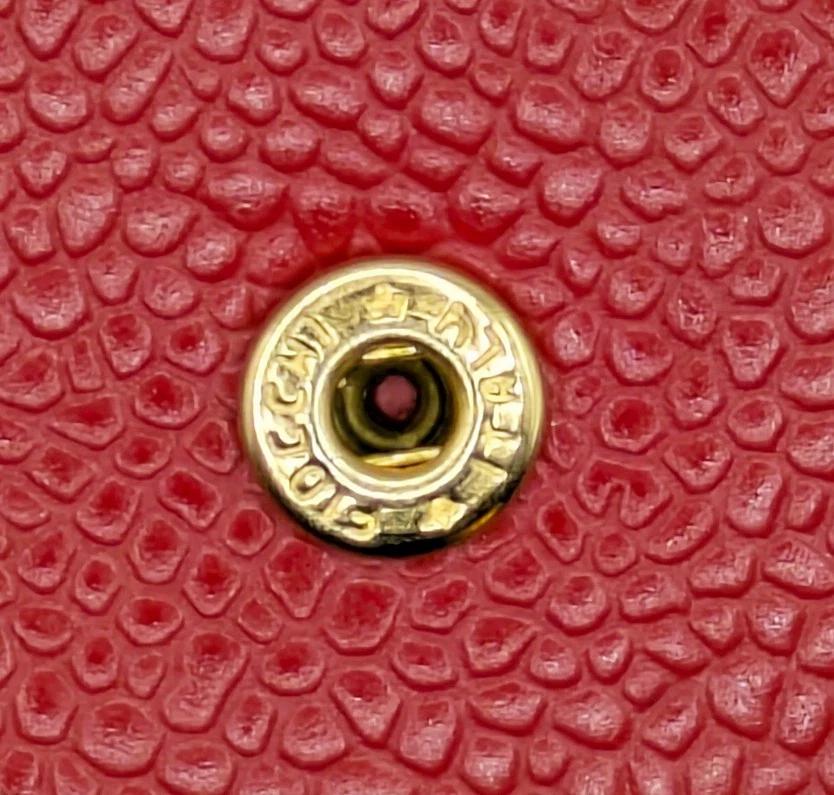 1980S Givenchy Red Madras leather wallet, separate compartment or coins, notes and cards, front gold tone metal logo, flat closure, made in France 

Dimensions: 10x10cm

Condition details: vintage, 1980s, light wear, very good, 8/10