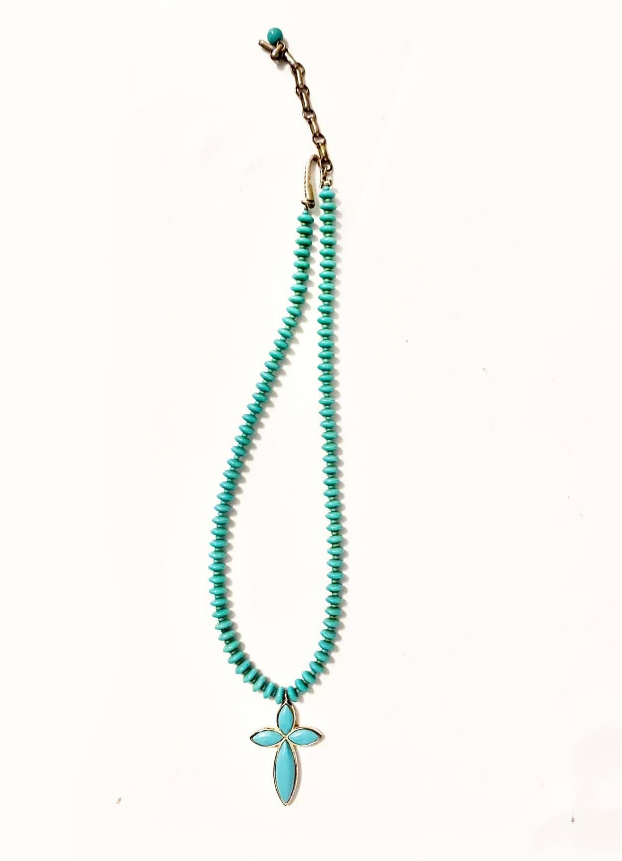 1980's Givenchy Turquoise necklace, silverware, cross pendant, adjustable length This stunning piece of jewelry is designed with a piece of turquoise, and is adjustable to fit all neck sizes. A timeless piece that adds elegance and sophistication to