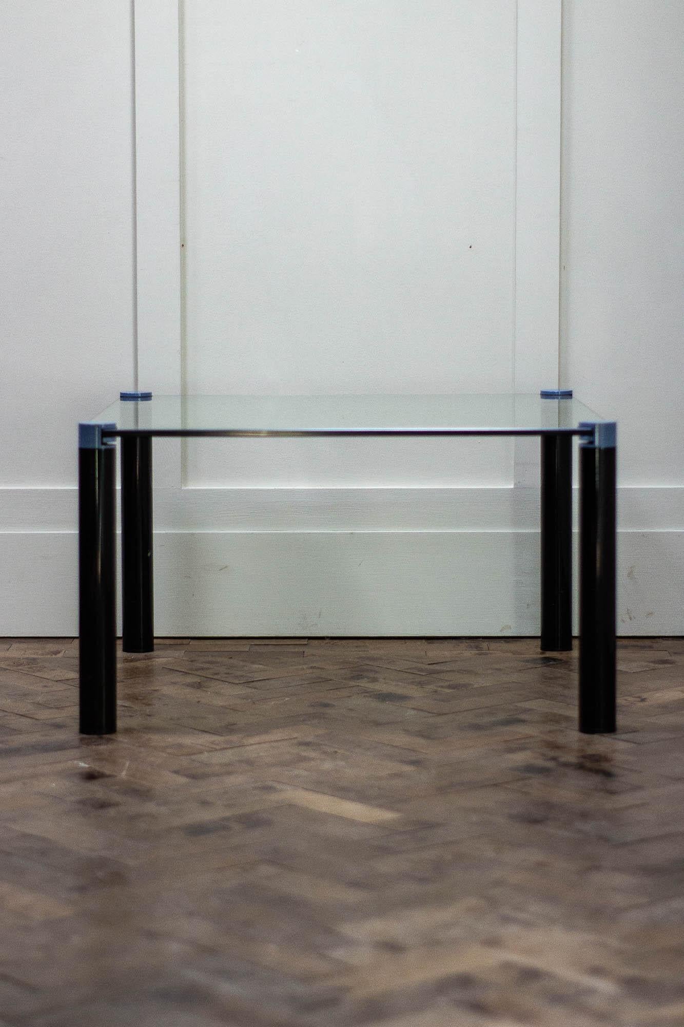 1980s Coffee/Side table with clear glass top and screw off legs.

The two port tubular steel legs are painted black with a purple top section. 

Inspired by the designer Peter Ghyczy.

Height 41cm
Width 70cm
Depth 70cm