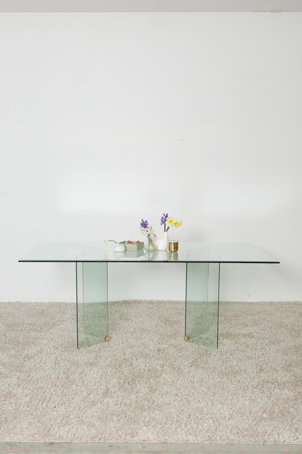 1980s glass dining table seats 6-8 people in style of Pace Collection

Beautiful all glass modern dining table in style of the Pace Collection with ½” beveled glass top and brass plated connectors on bases. Simple, sleek and elegant. The perfect