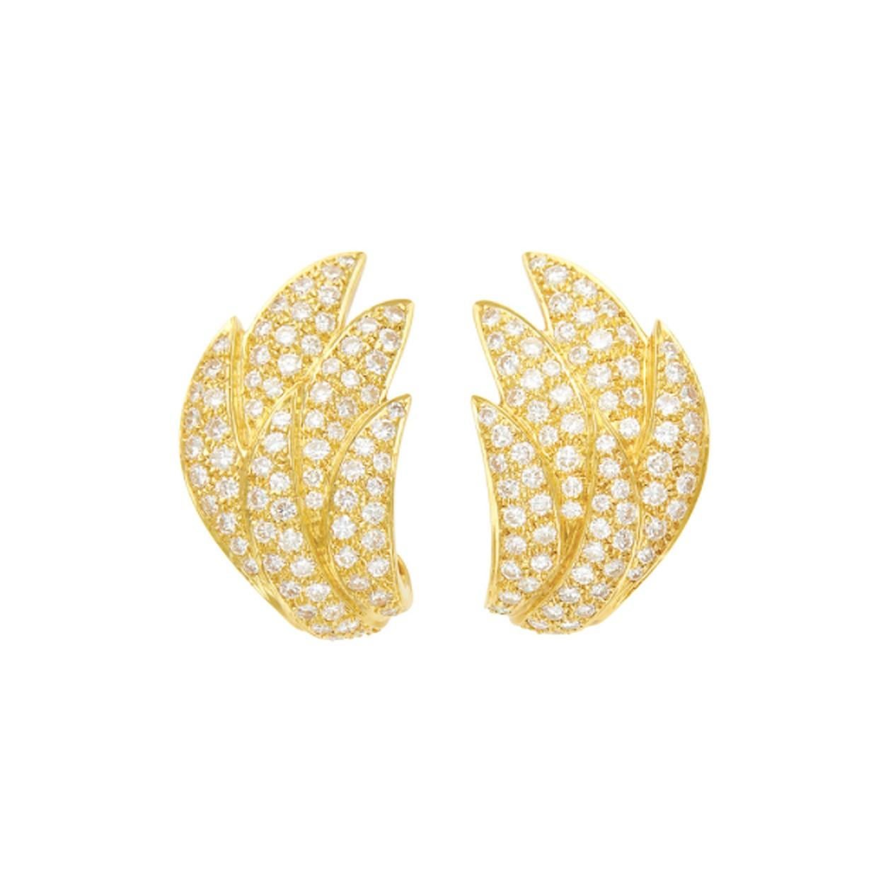 An elegant pair of pavé diamond earrings crafted in 18k yellow gold with foliate design. Made in America, circa 1980.