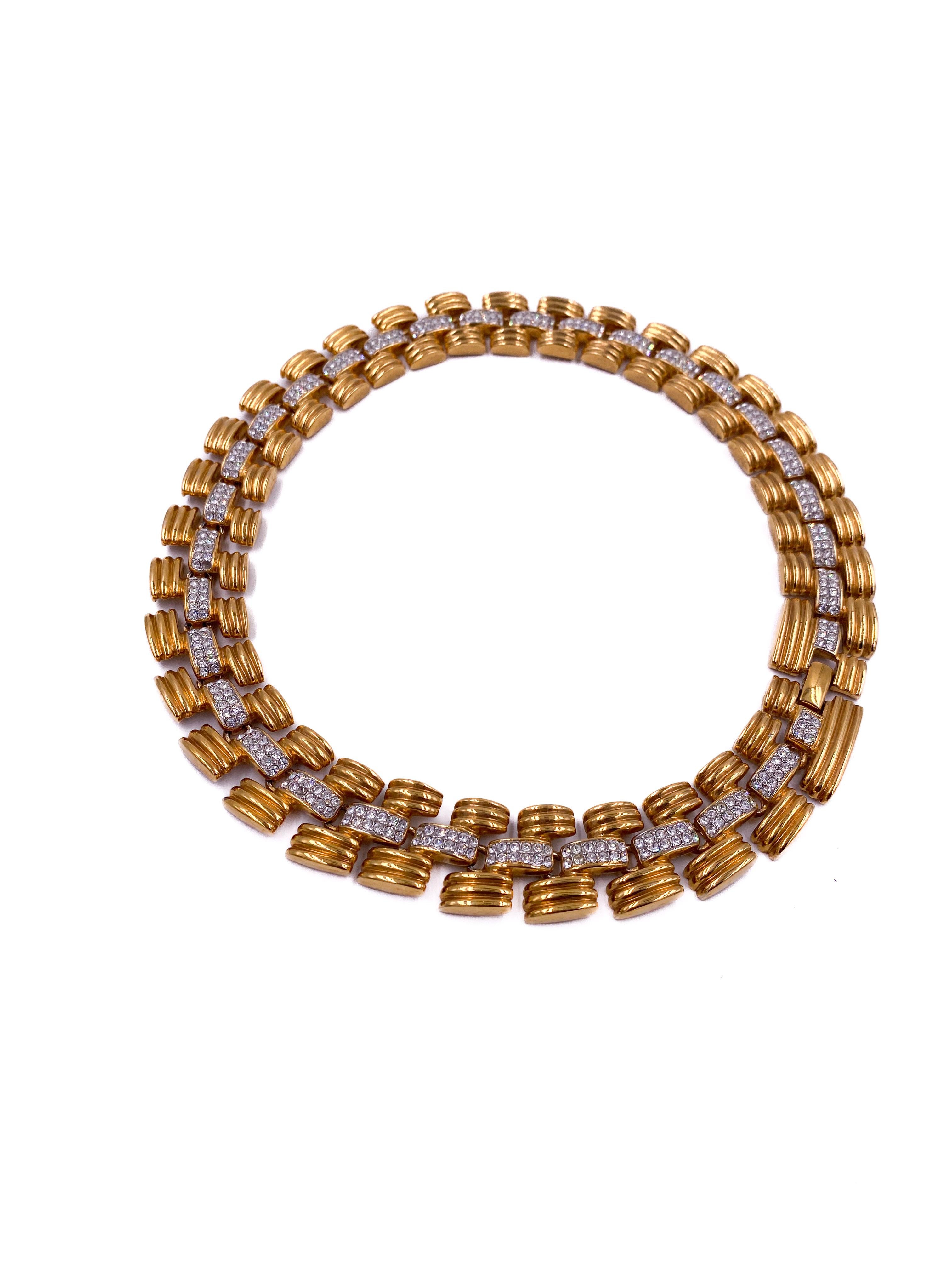This 1980s vintage gold chain necklace features a perfect balance of gleaming gold and sparkling rhinestones, creating a striking centerpiece high on the neck. Designed as a unisex accessory, it adds a bold yet refined touch to any outfit, embodying