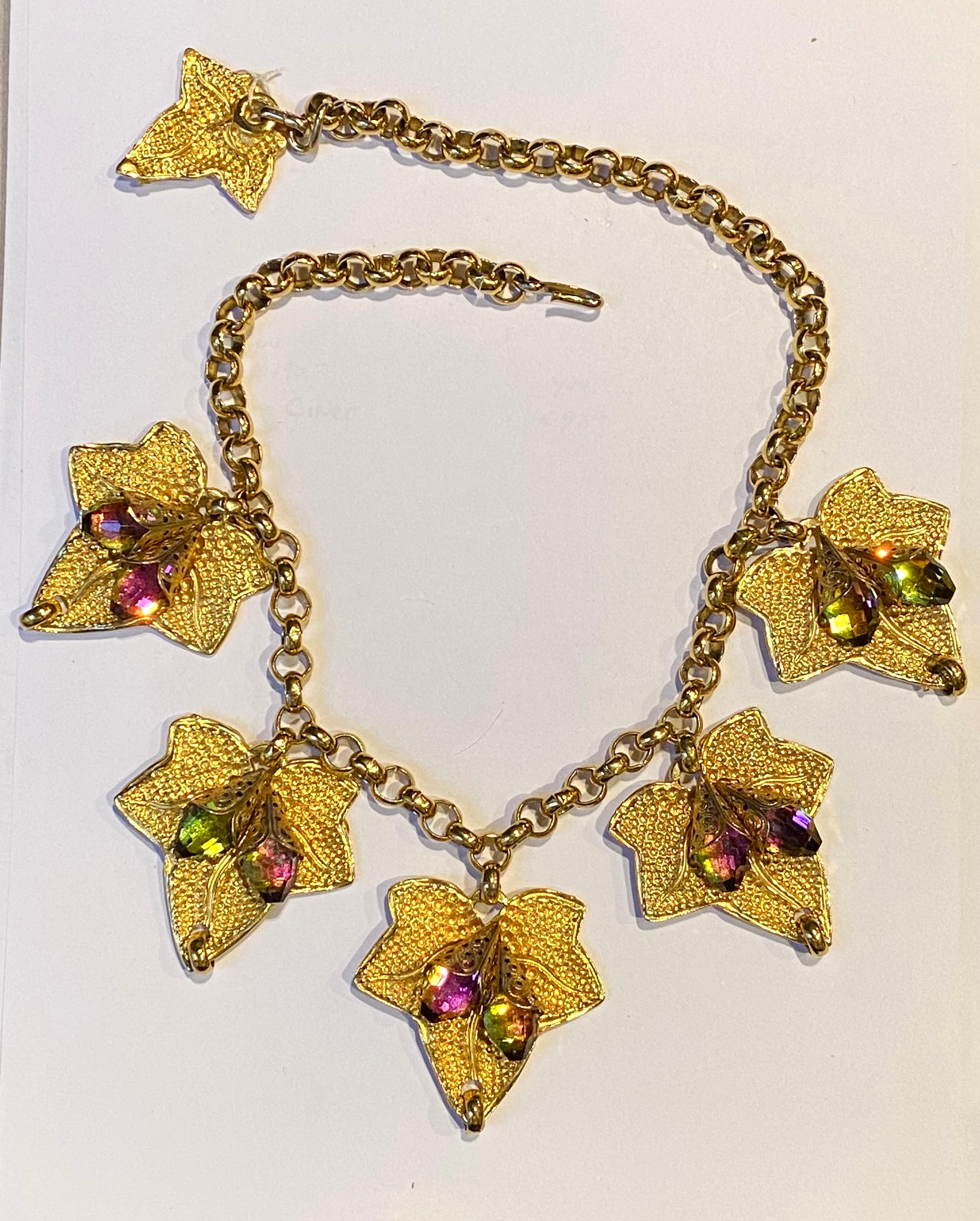 A lovely ivy leaf statement necklace from the 1980s. Unsigned yet well designed and crafted. The necklace is comprised of a .32 if an inch round cable link strand with five large and one small ivy leaf pendants. The five large leaves measure 2.13