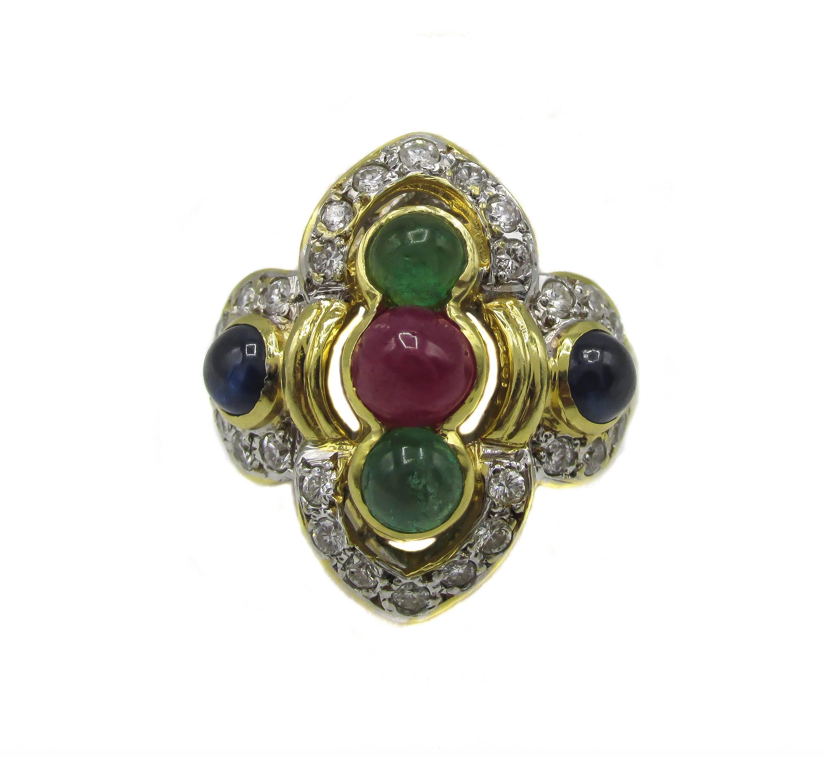 Chic 1980's 18 karat yellow gold ring with a center navette shaped design set with 7 round brilliant cut diamonds on either side and 2 cabochon emeralds and 1 cabochon ruby bezel set in the center. On either side of the shank, 1 bezel set cabochon