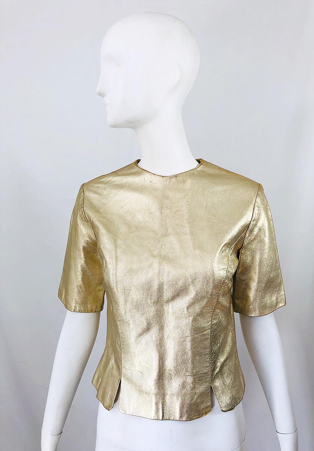 Fabulous 1980s does 1950s gold leather distressed shirt! Features slightly distressed gold leather. Great tailored fit with gold leather buttons up the back. Fully lined in silk. Can easily be dressed up or down. Great belted or alone with jeans,