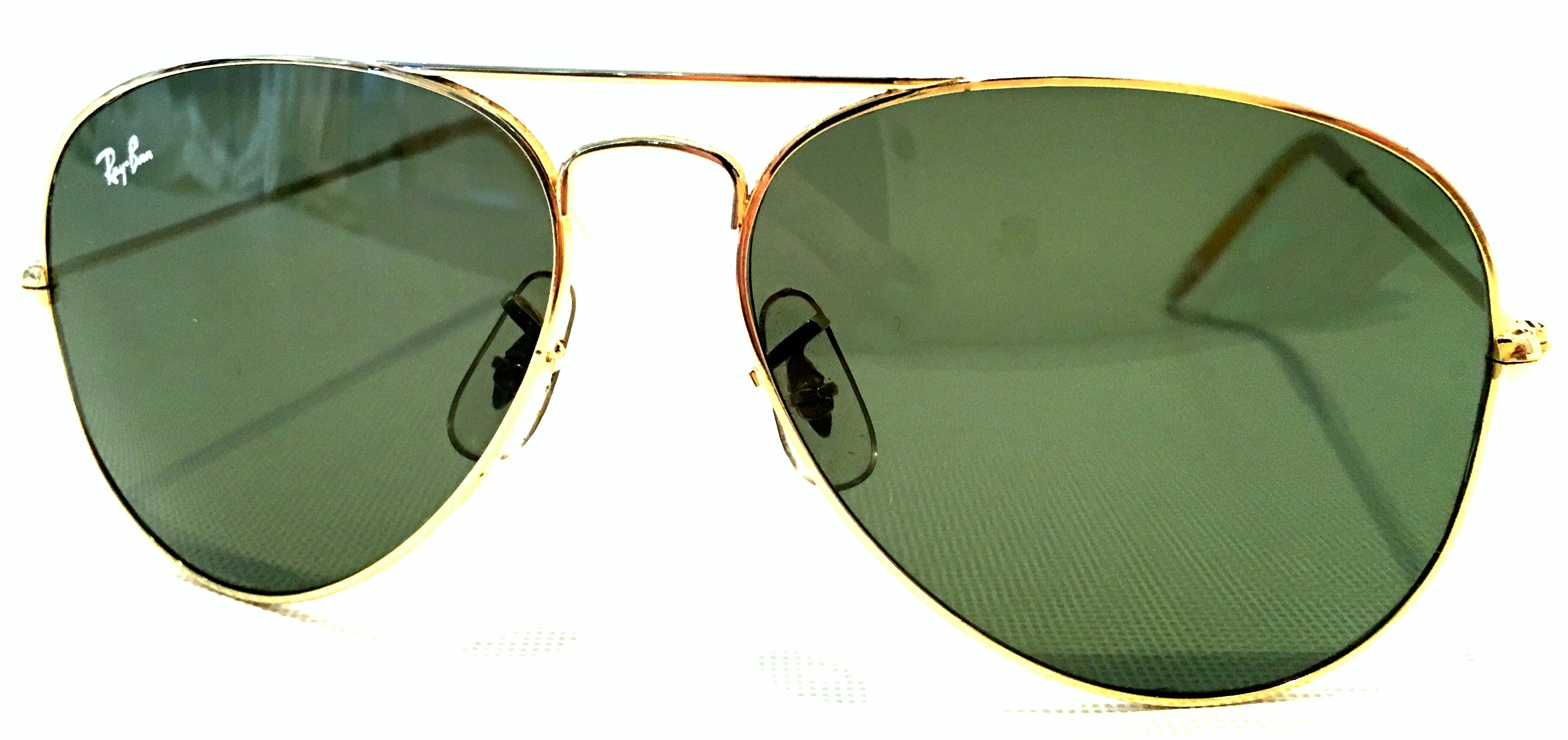 1980'S Gold Plate Tear Drop Aviator Sunglasses & Case By, Bausch & Lomb Ray Ban USA. These classic and timeless tear drop shape aviator sunglasses feature, gold plate frame with military green/gray lens. The tear drop shaped lenses are
