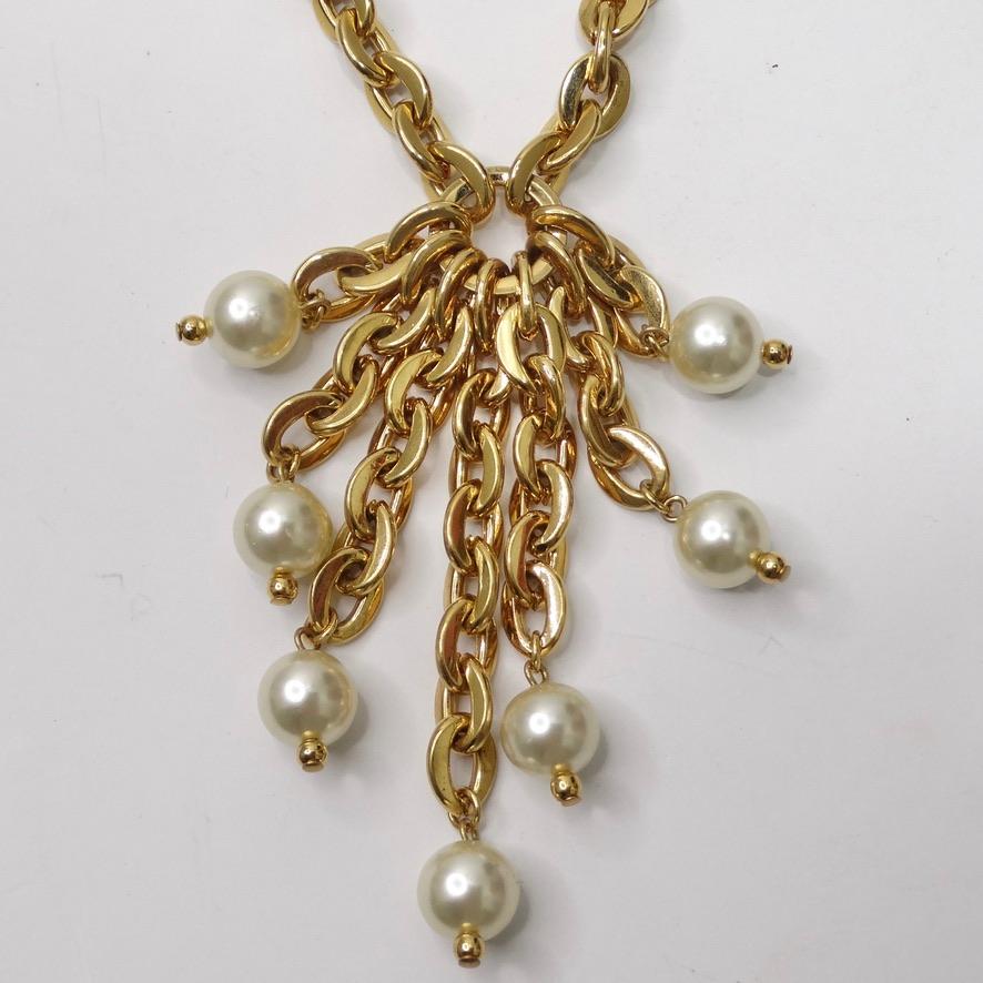 Do not miss out on this stunning gold plated faux pearl tassel necklace circa 1980’s! Channel the playful modernism of the 1980s with this beautiful gold plated necklace featuring a tassel pendent compromised of a plethora of gold tone chains and