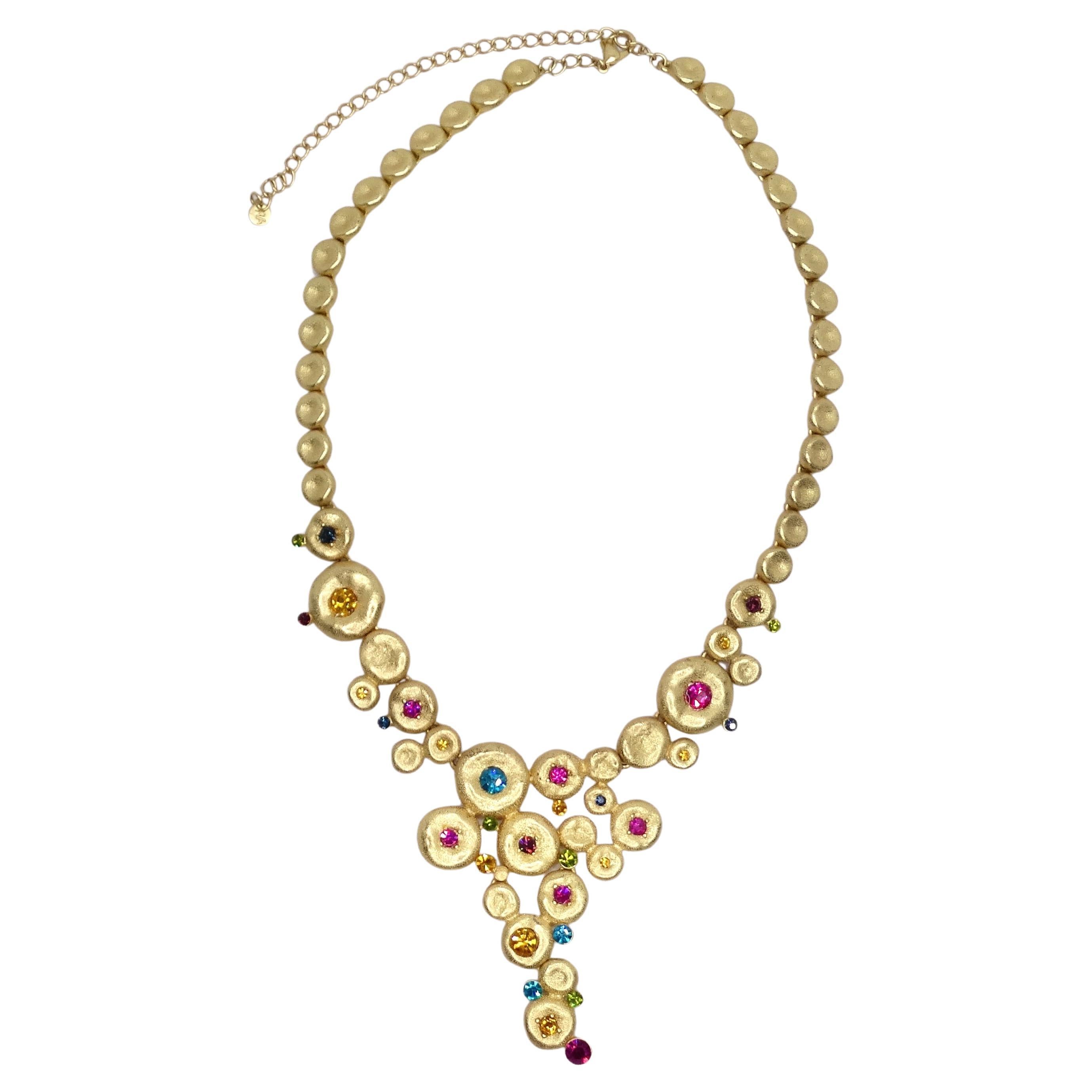 Introducing the 1980s Gold Tone Multicolor Rhinestone Necklace – a stunning piece that captures the essence of an era known for its bold and glamorous fashion. This adjustable choker necklace is not just an accessory; it's a time machine that takes
