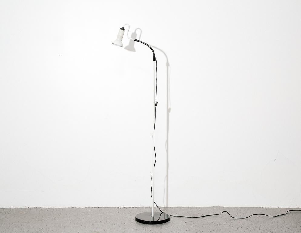 White and black gooseneck floor lamp with perforate shade.