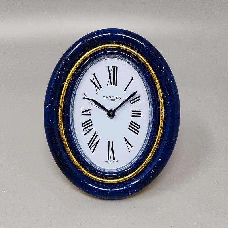1980s Gorgeous Cartier alarm clock pendulette. Made in Swiss.
It's lapis lazuli and golden metal with manual winding-. Clock case numbered 24219. With original case, lined with red leather and with certificate and instructions. It works perfeclty
