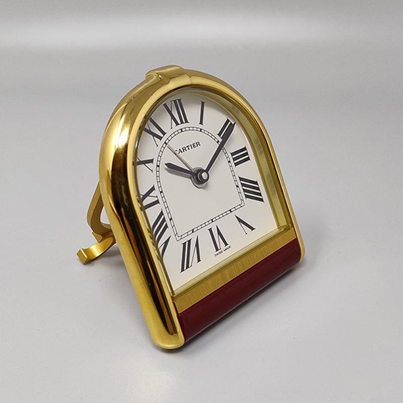 1980s Gorgeous Cartier Romane alarm clock pendulette. Made in Swiss. It's in gold plated 18K. White enamel dial. Clock case numbered 00883/certificate 0H0W0100001. With original case, lined with red leather and with instructions and certificate. It