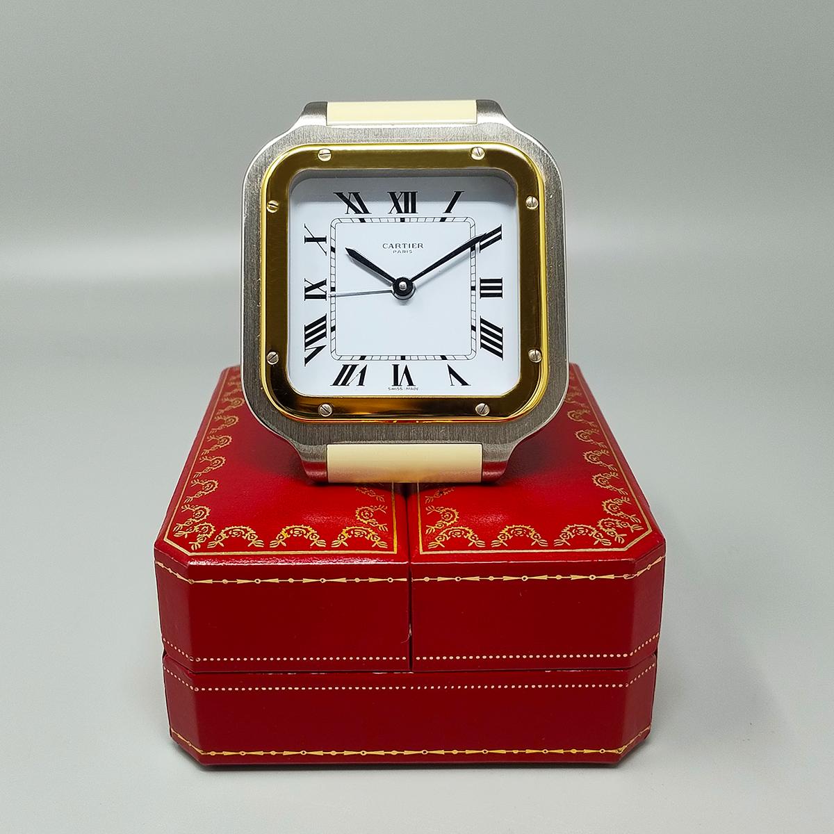 1980s Gorgeous Cartier Santos alarm clock pendulette. Made in Swiss. It's in gold plated 18K. White enamel dial. Clock case numbered 7508 09100. With case, lined with red leather. It works perfeclty and is in excellent condition. 
Dimension:
2,75 W