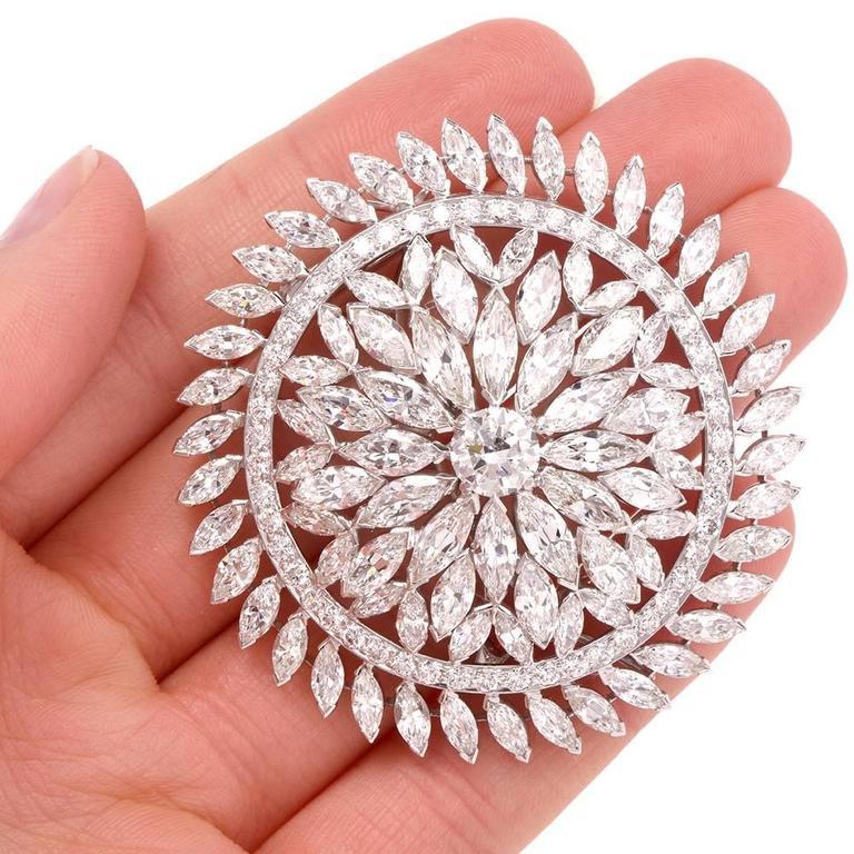 This immaculately crafted 1980's Grand lapel brooch and pendant is designed as an openwork orbicular plaque, rendered in solid platinum. This exquisite and versatile piece of jewelry is centered with an approx. 1.70 carats genuine round