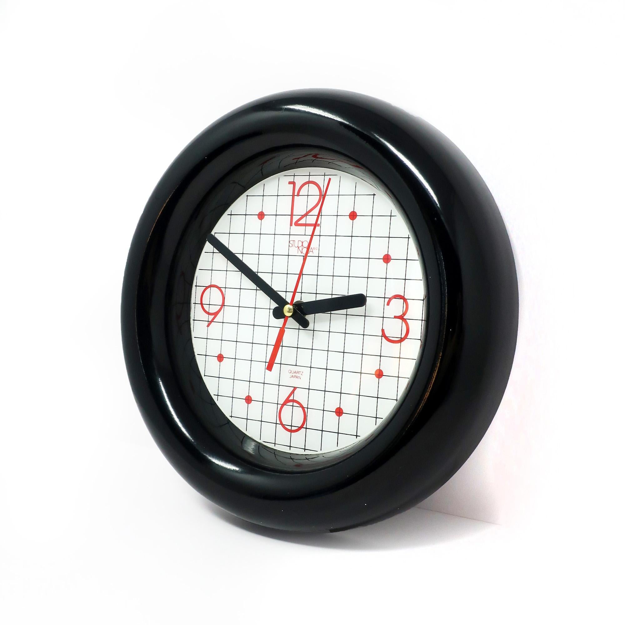 A very cool and unique 1980s wall clock by Studio Nova Japan with a cartoonish black border, white face with black grid lines, red numbers and black and red hands.  Will look great in your office, living room or kitchen!

In very good vintage