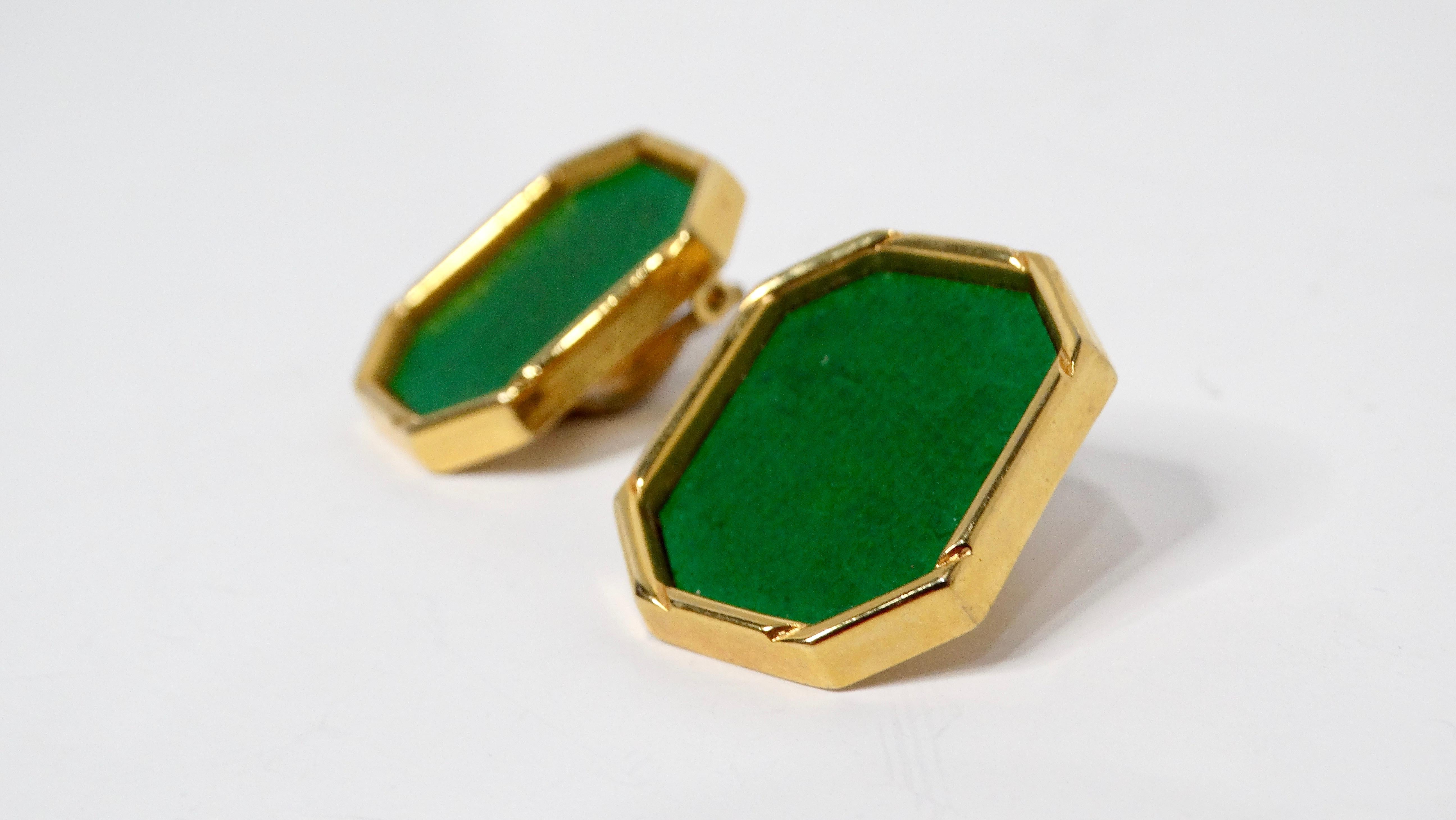 Step back into the vibrant and eclectic fashion of the 1980s with these stunning Green Leather Gold Tone Octagon Clip-On Earrings. Featuring a striking green faux leather center encased in a bold gold-toned octagonal frame, these earrings