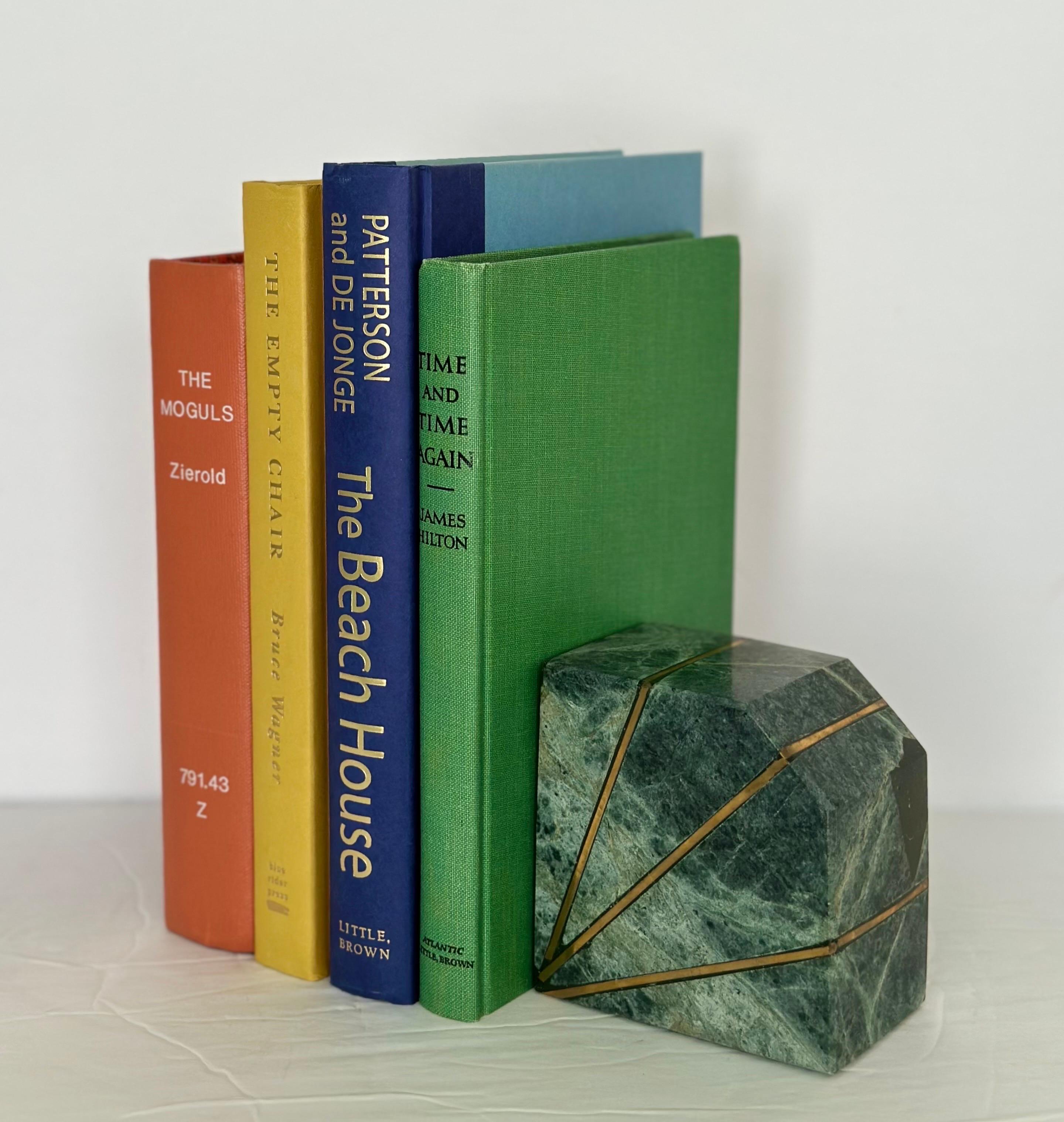 We are very pleased to offer a stunning pair of bookends, circa the 1980s. These sturdy blocks are crafted from green Verde Guatemala marble, a rich and vibrant green stone known for its distinctive veining and depth of color. The pair features