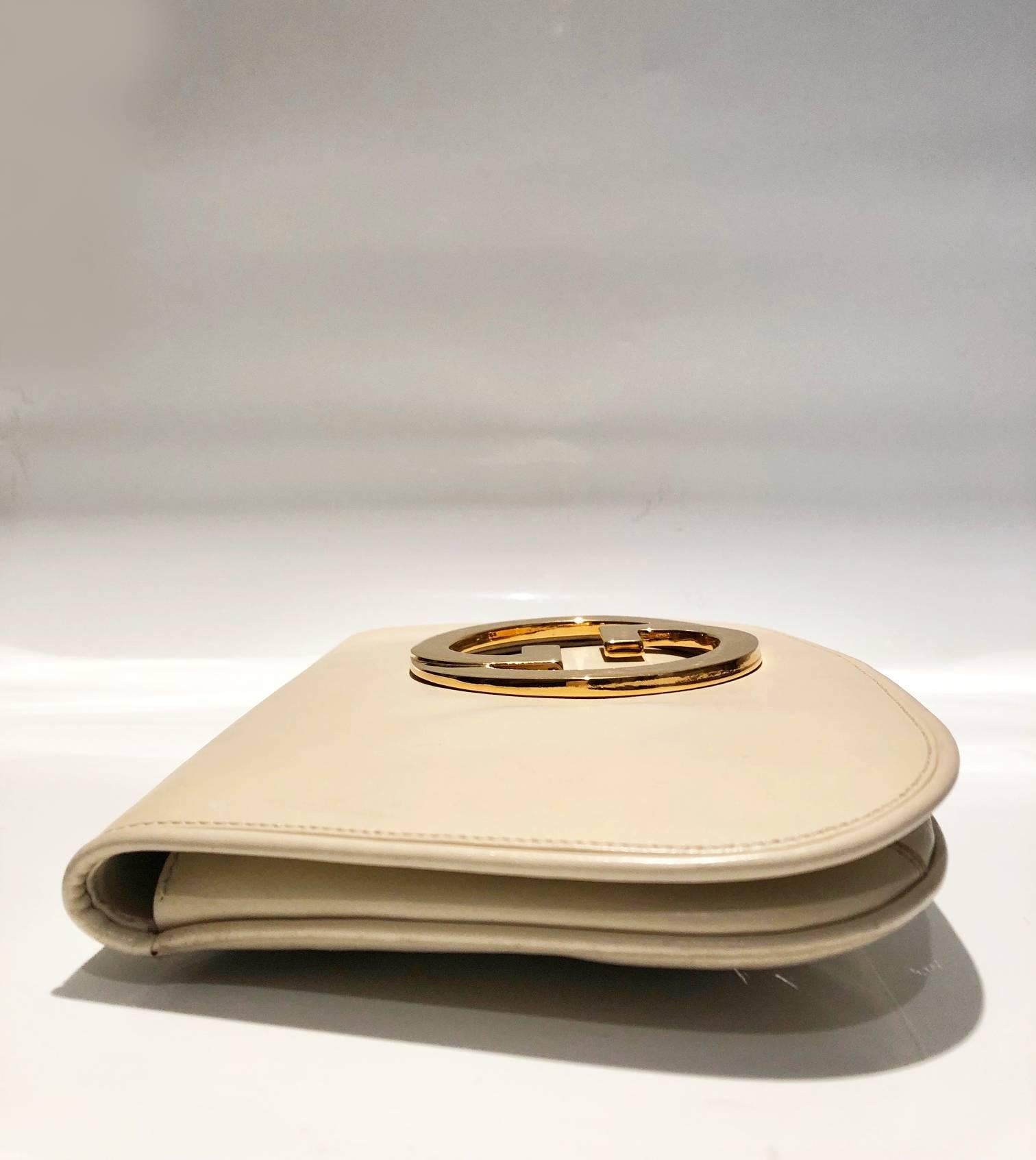 Christian Dior Top Handle Houndstooth Box Clutch Bag

Gucci Blondie Unicorn ivory cream leather clutch bag, Gold Gucci front logo, weighted closure,  small internal pocket, leather and suede lining. 
Gucci authentication number is stamped inside,