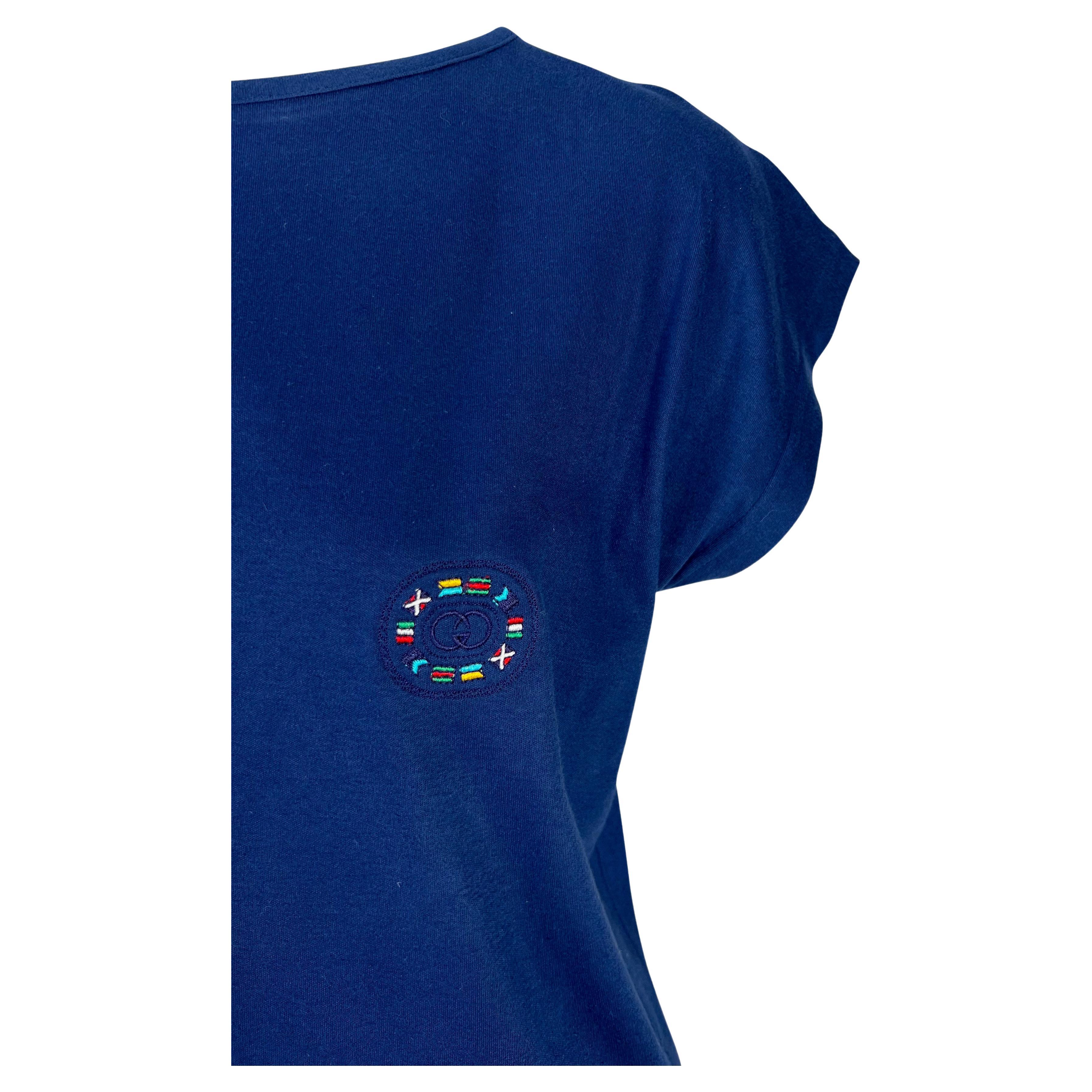 Presenting a navy blue branded Gucci t-shirt. From the 1980s, this t-shirt features a nautical motif with the 'GG' Gucci logo at the bust surrounded by sailing flags. The top is made complete with petal sleeves.

Approximate measurements:
Size -
