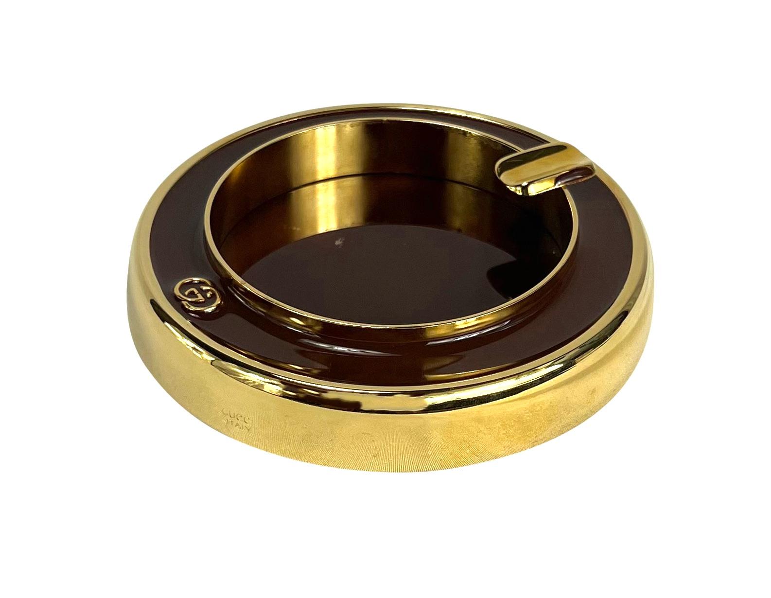 TheRealList presents: a stunning gold-tone Gucci ashtray. From the 1960s, this small ashtray is constructed with gold-tone metal and features brown enamel details. The ashtray is made complete with Gucci's famous 'GG' logo placed on top. 

Follow us