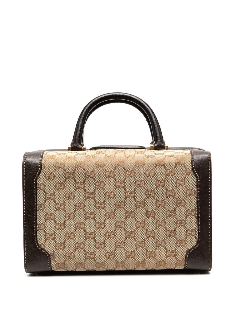 Gucci brown canvas & leather  vanity-case bag featuring a brown leather finishing, top leather handles, a canvas logo pattern, gold-tone hardware, inside compartments, an inside gold tone logo stamp. 
Width 11.8in. (30cm) 
Height 7.8in. (20cm)
Width