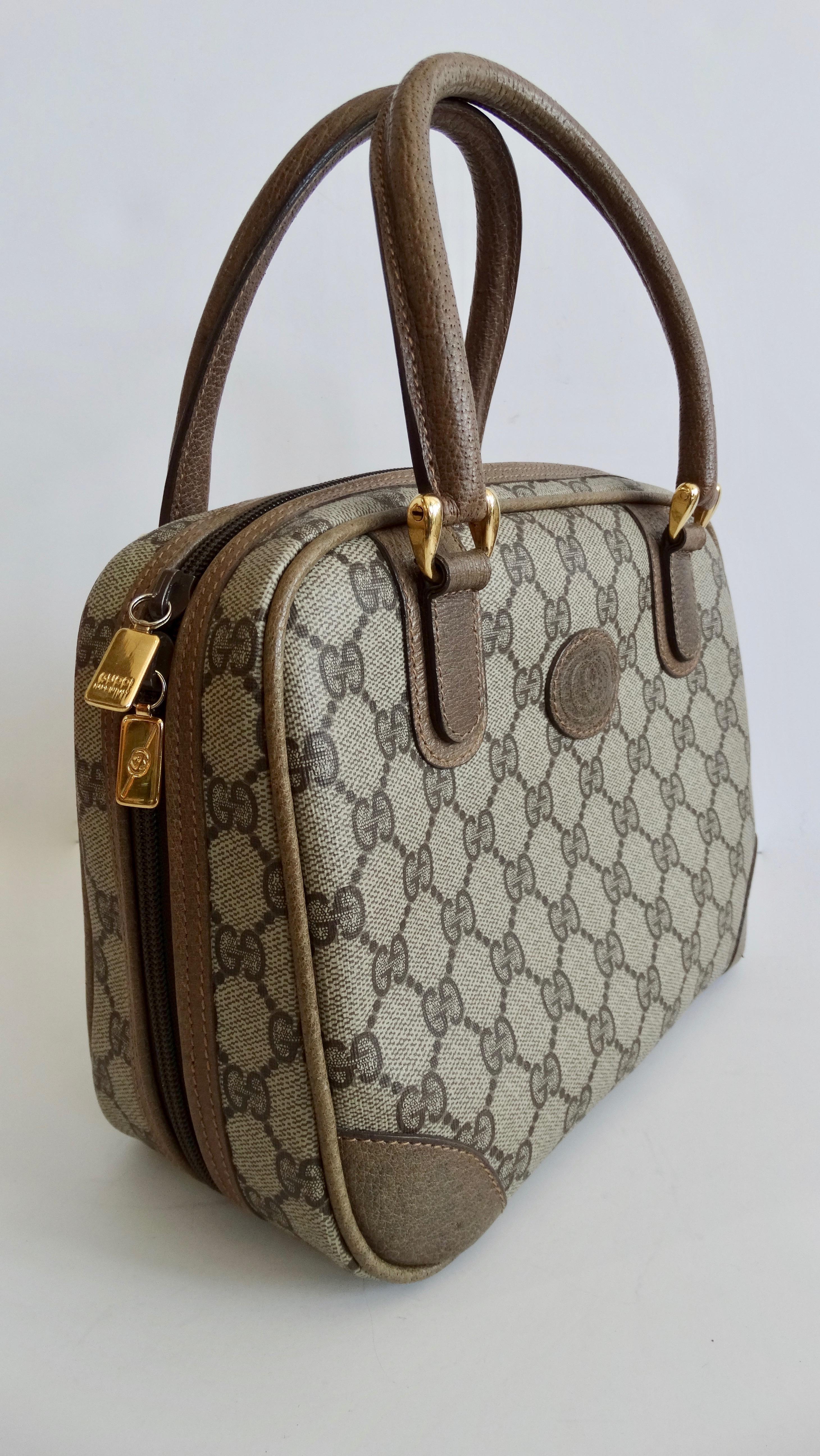 Calling all Gucci lovers! Your perfect everyday bag is here! Circa 1980s, this adorable Gucci handbag features the iconic Gucci monogram and gold plated hardware. Soft brown leather covers the dual top handles and exterior trim. Front face of bag