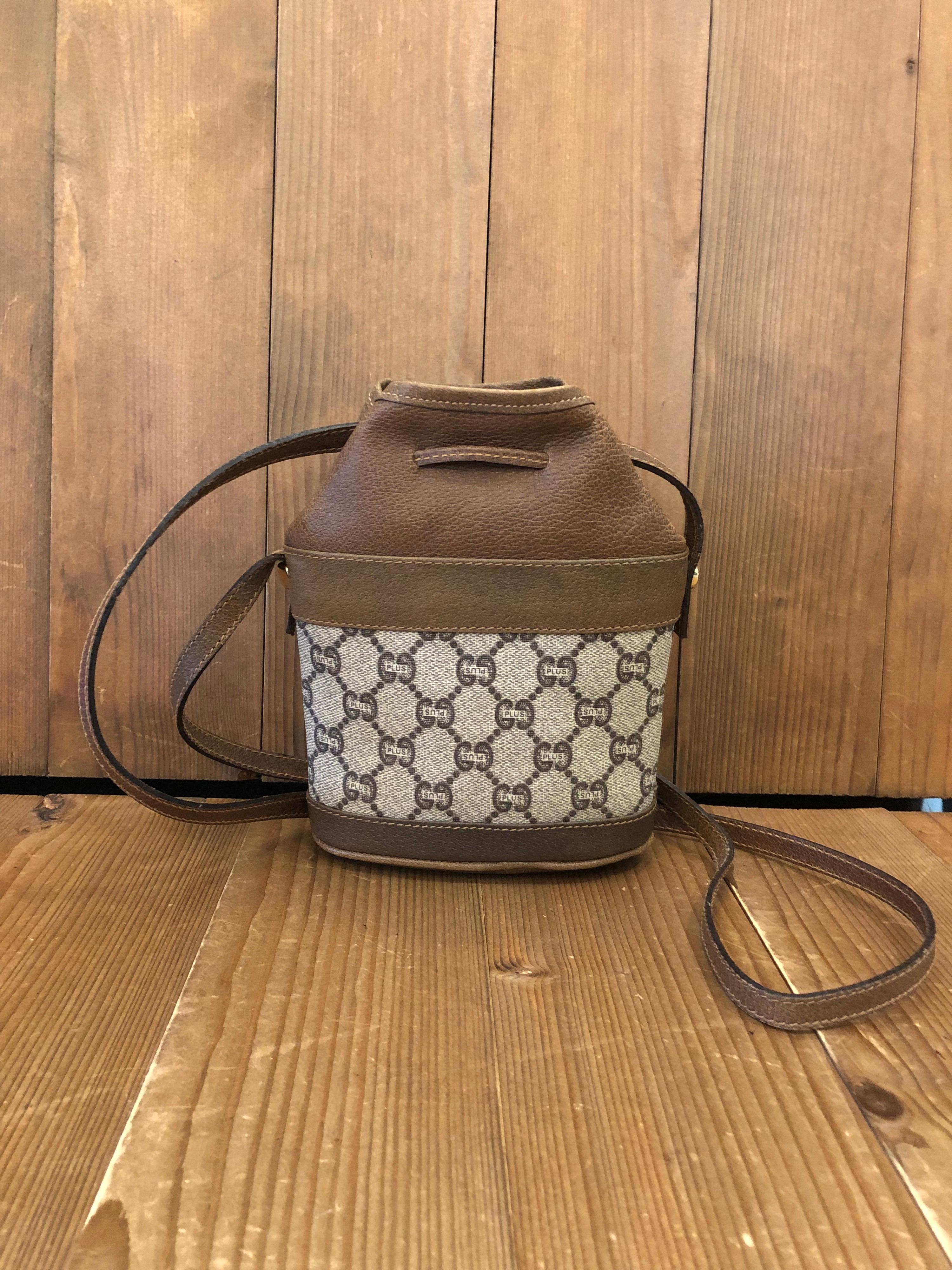 1980s GUCCI Plus mini drawstring crossbody pouch bag in brown GG Plus monogram canvas. Drawstring closure. Made in Italy. Measures 6.5 x 7 x 2.5 inches Drop 22 inches.

Gucci Plus was a spin-off from GUCCI in the 1980s by Pablo Gucci (son of Aldo